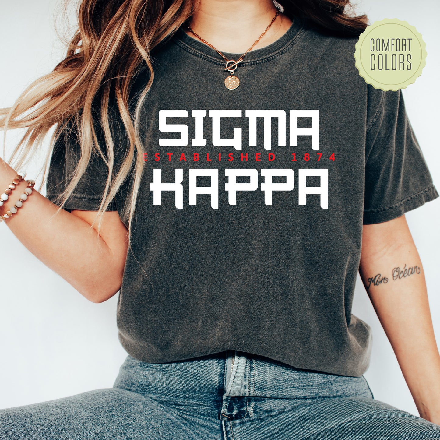 a woman wearing a black shirt that says stigma happa