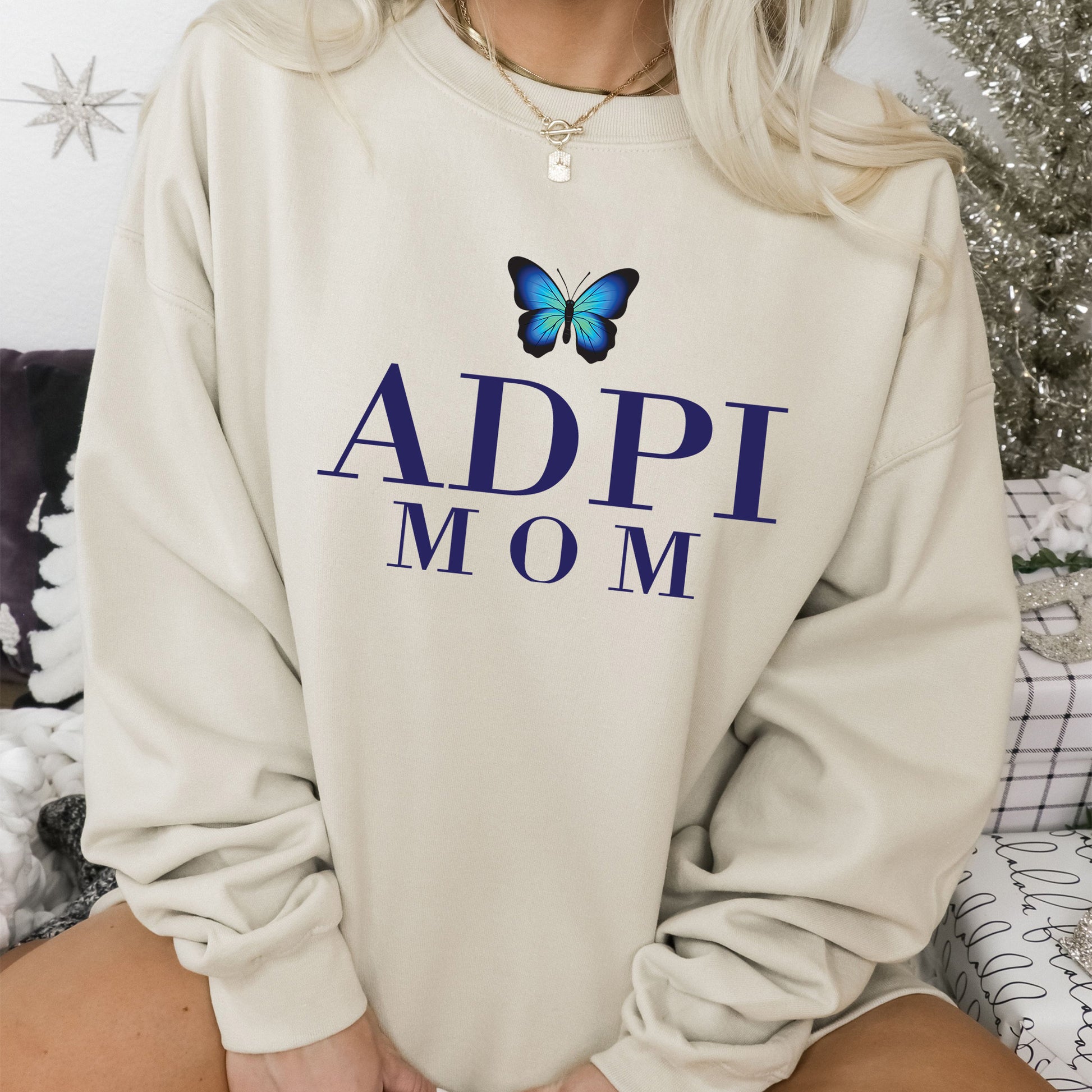 a woman wearing a sweatshirt with a butterfly on it