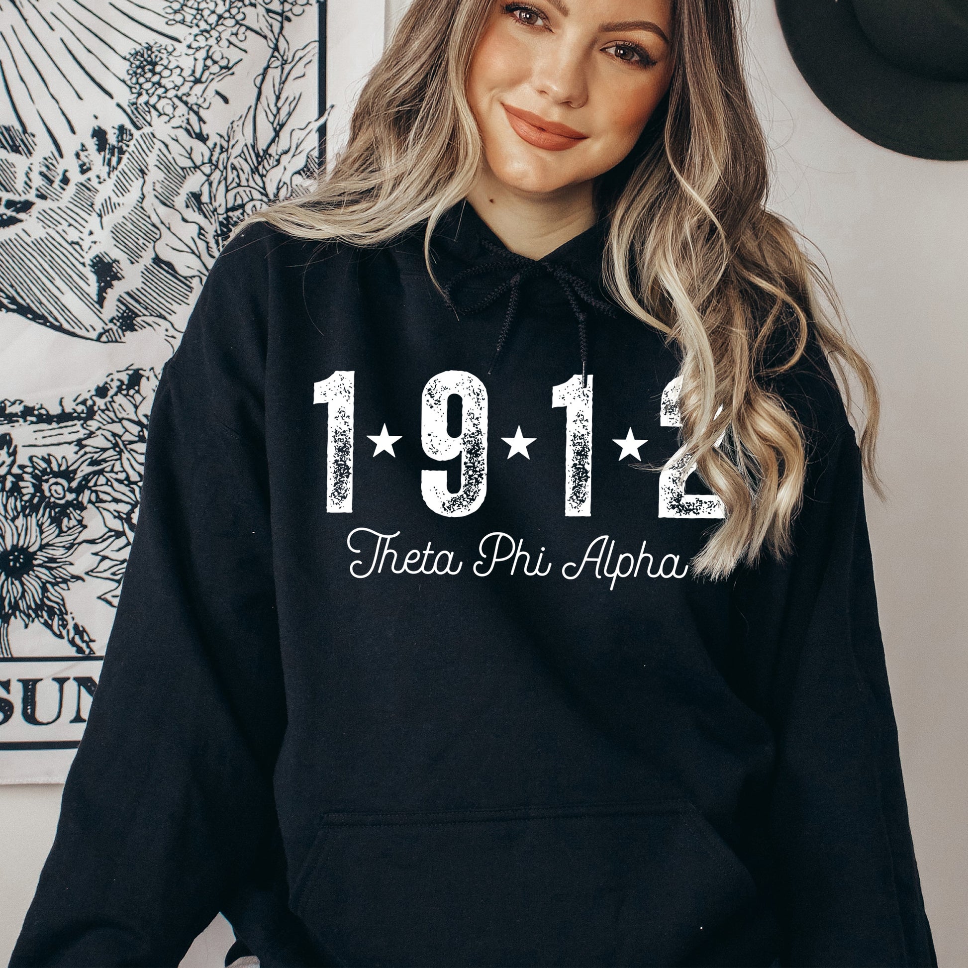 a woman wearing a black hoodie with the number 1911 printed on it