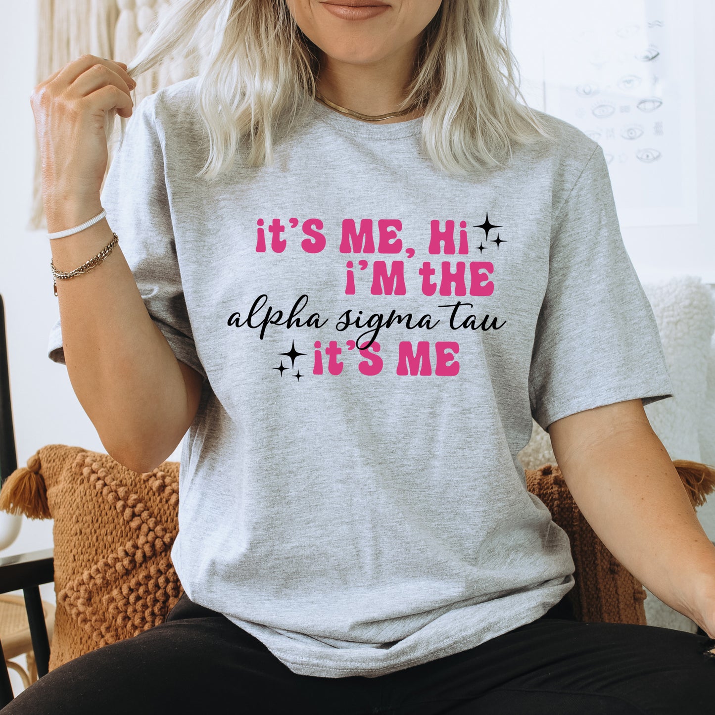a woman sitting on a chair wearing a t - shirt that says it's