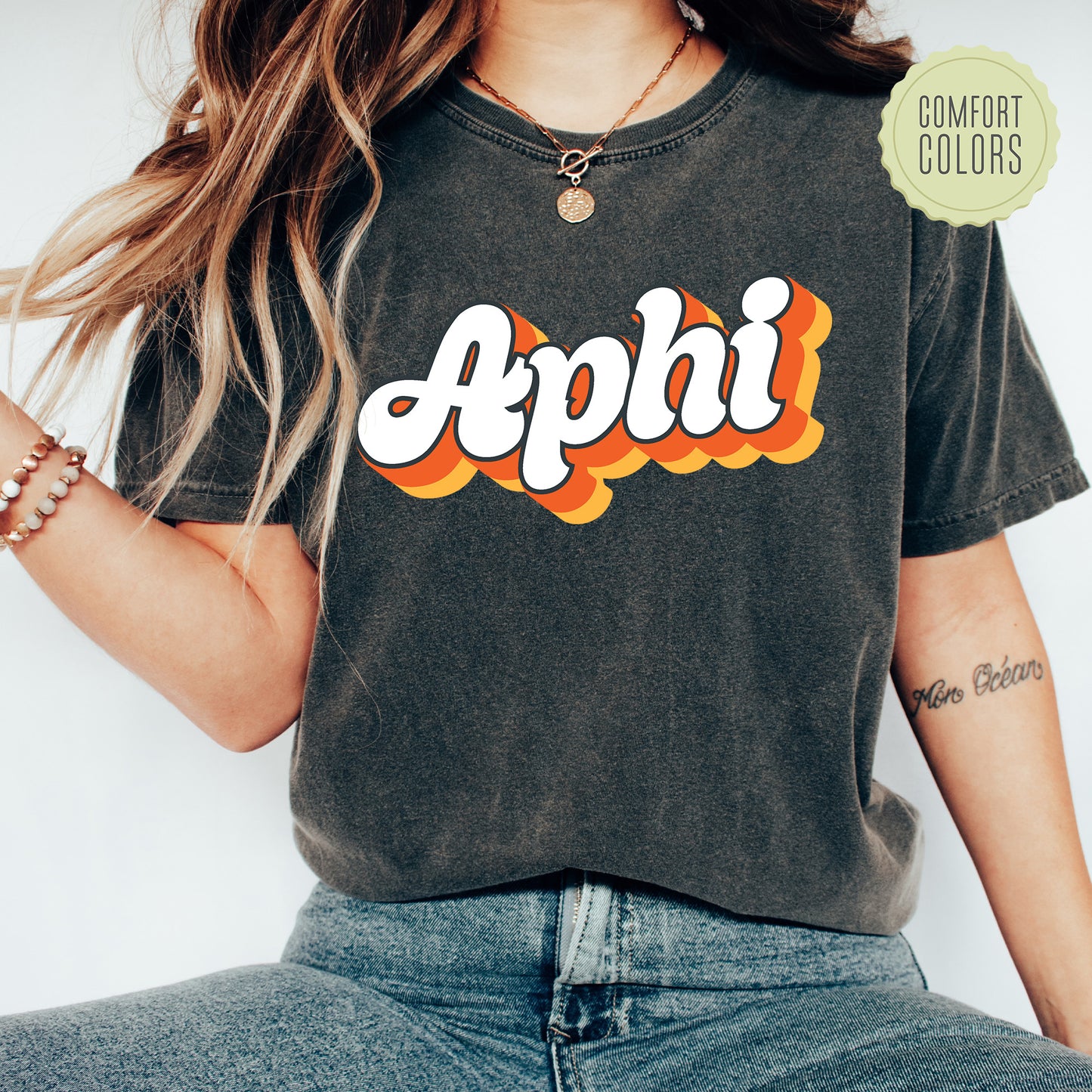 a woman wearing a black shirt with the word aphi on it