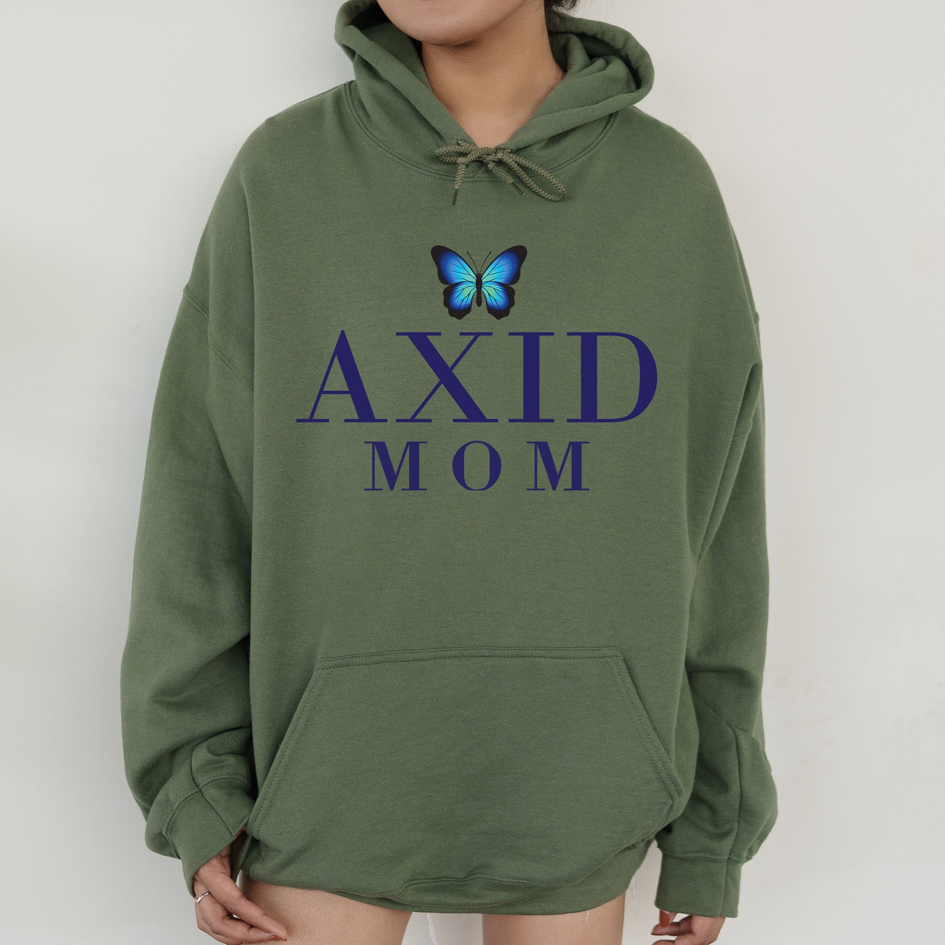 a woman wearing a green hoodie with a blue butterfly on it
