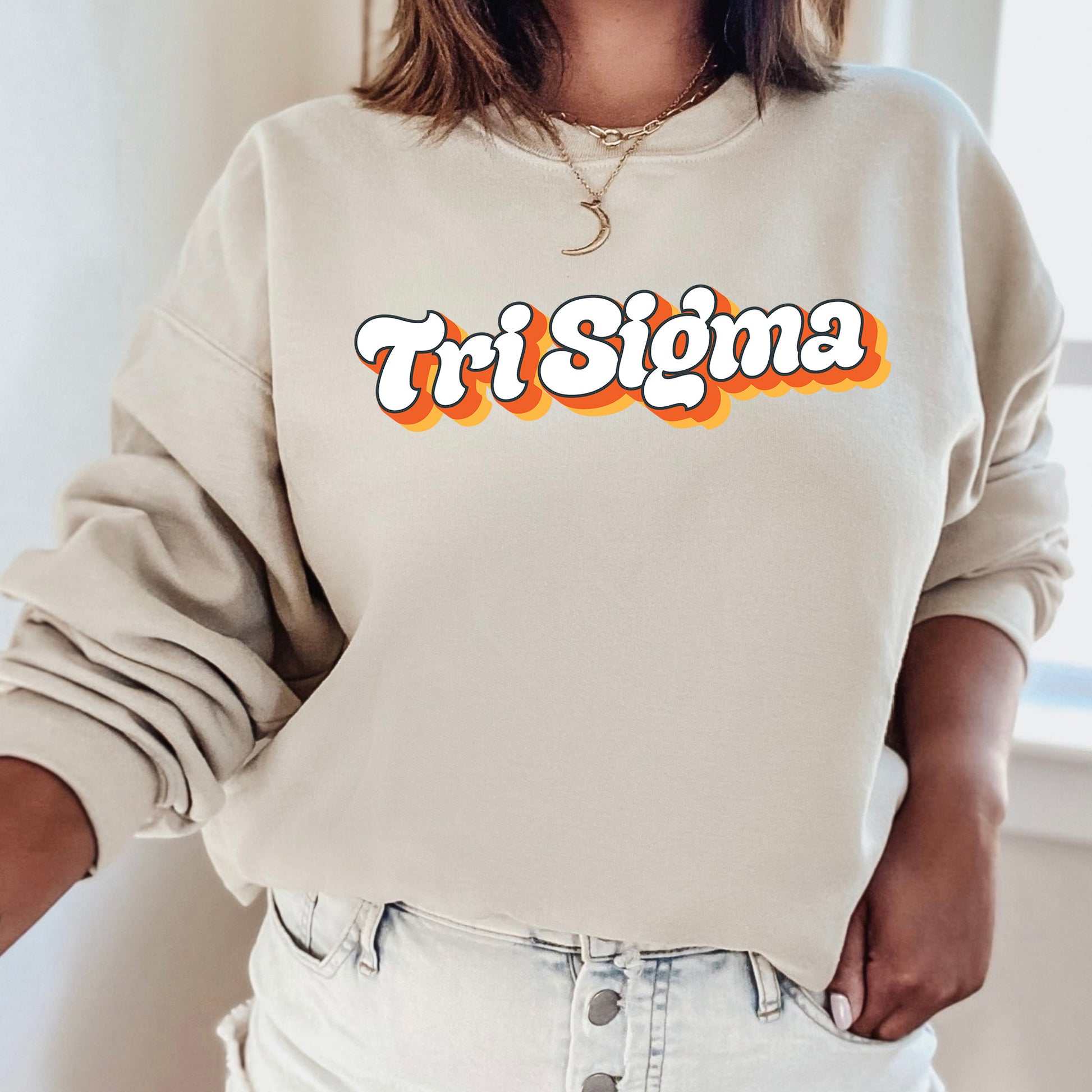 a woman wearing a sweatshirt with the word tri stigma printed on it