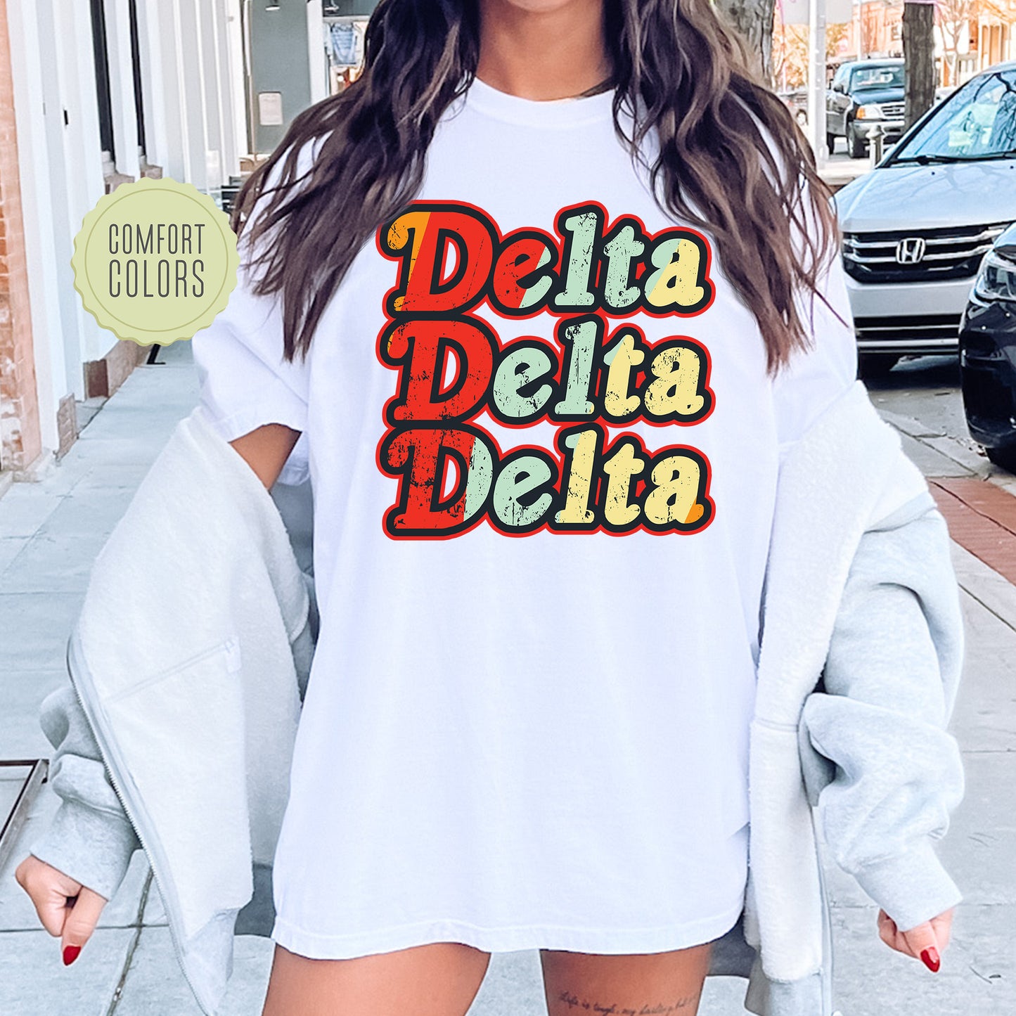 a woman wearing a white shirt that says delta delta