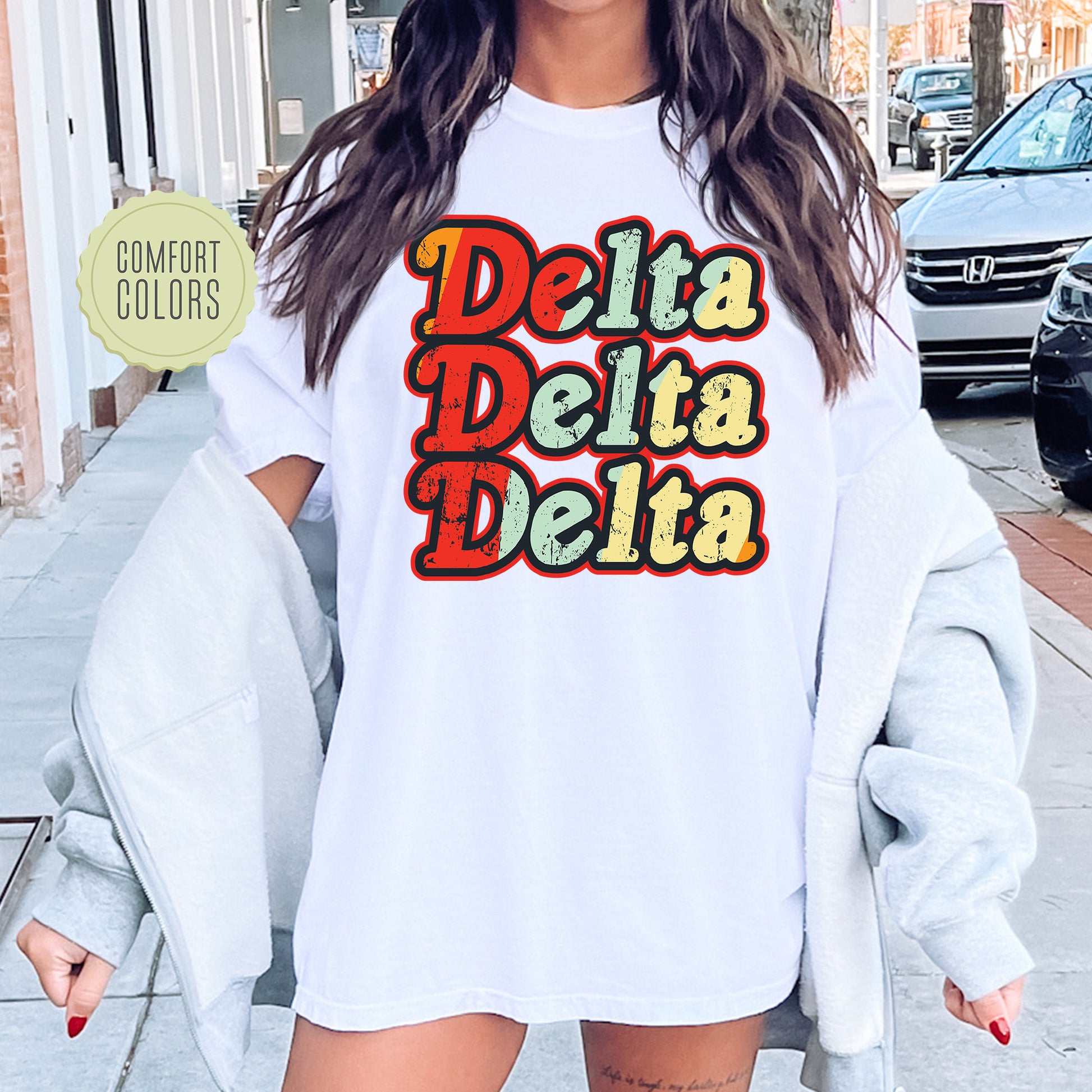 a woman wearing a white shirt that says delta delta