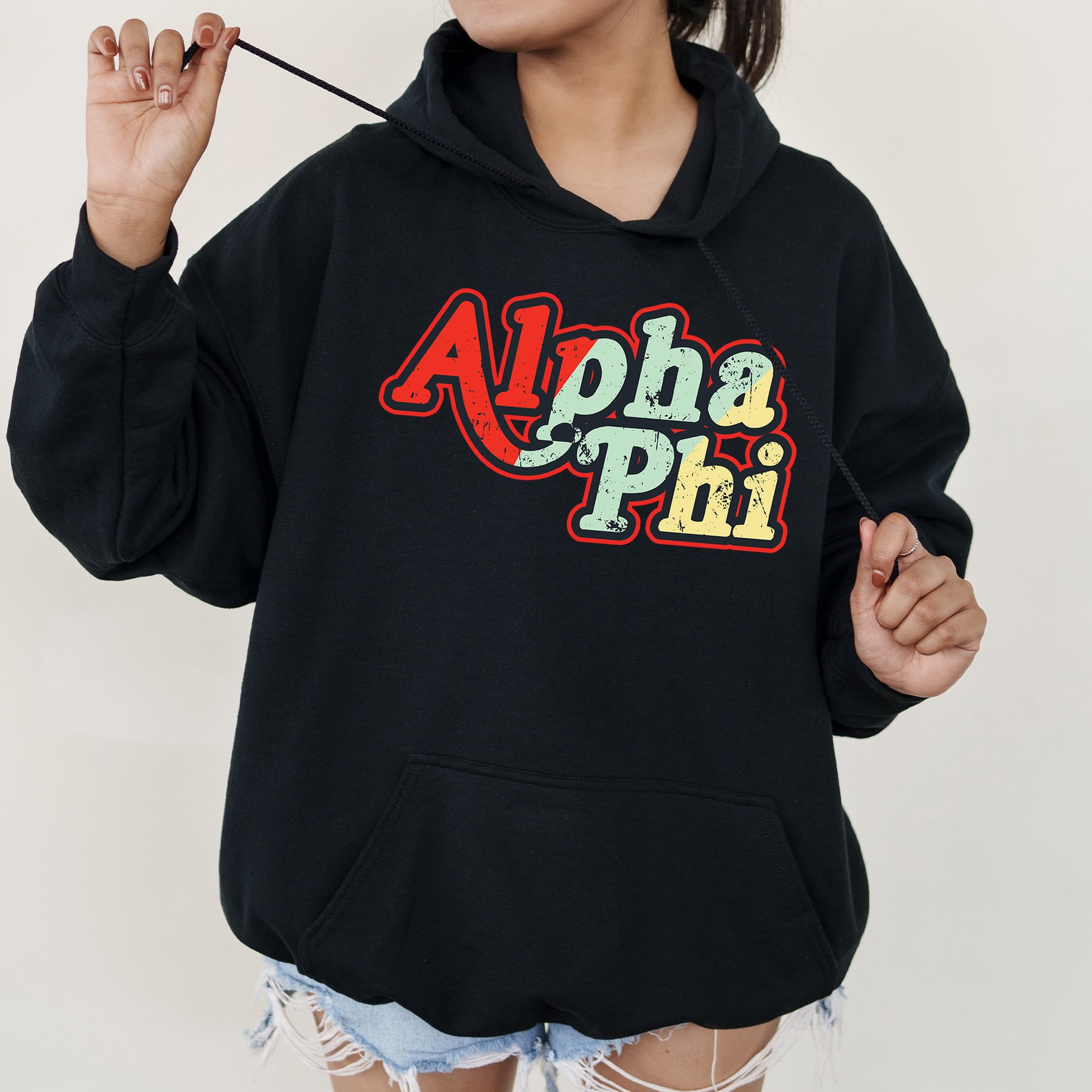 a woman wearing a black hoodie with the word aloha phi on it