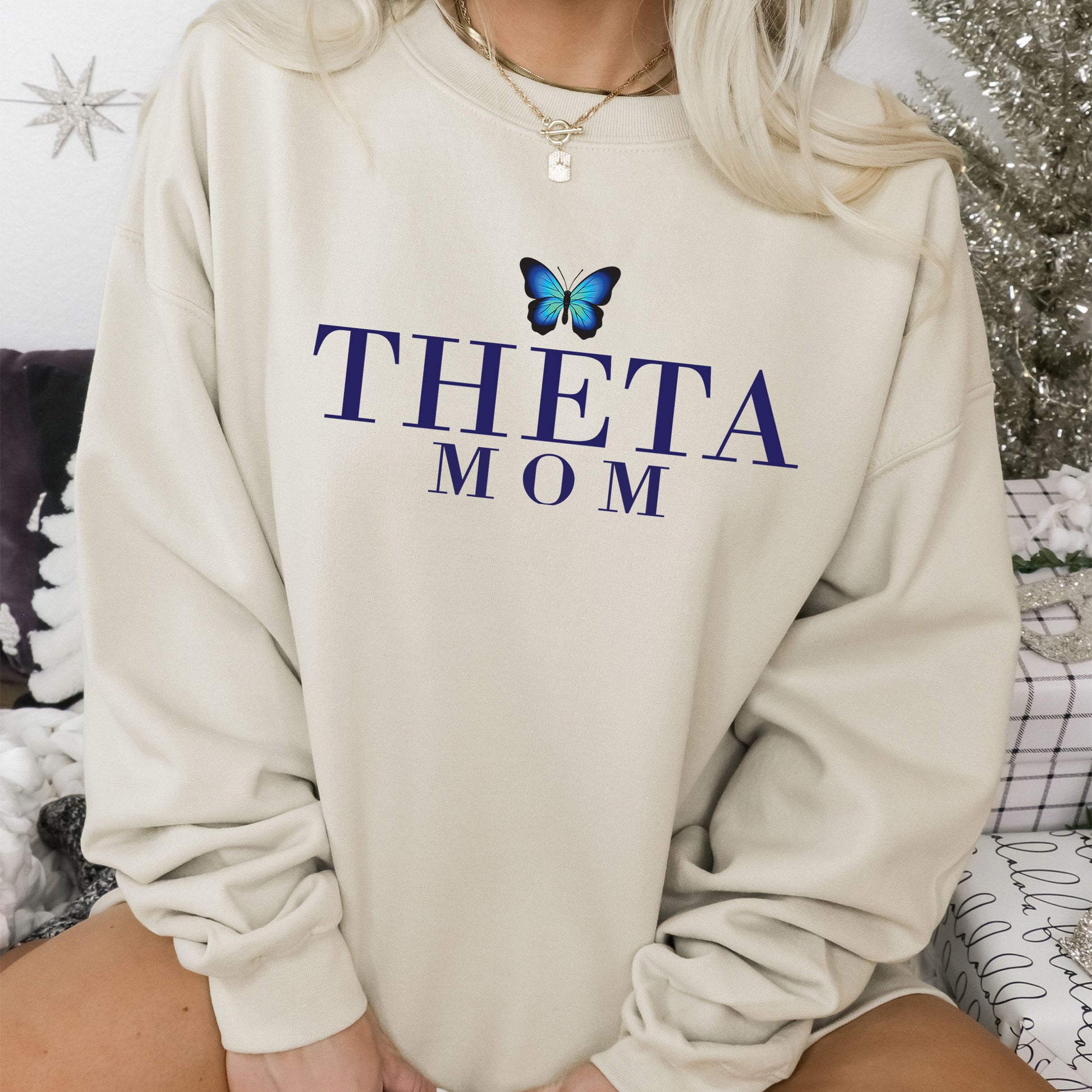a woman wearing a sweatshirt with a butterfly on it