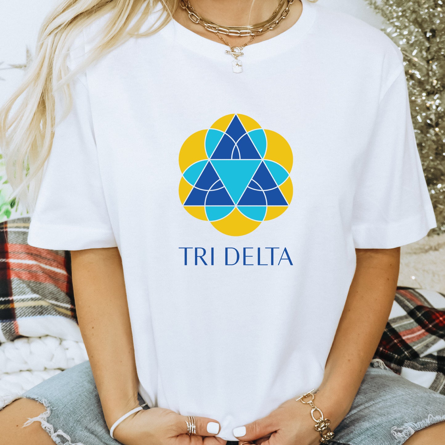 a woman wearing a white tri delta t - shirt