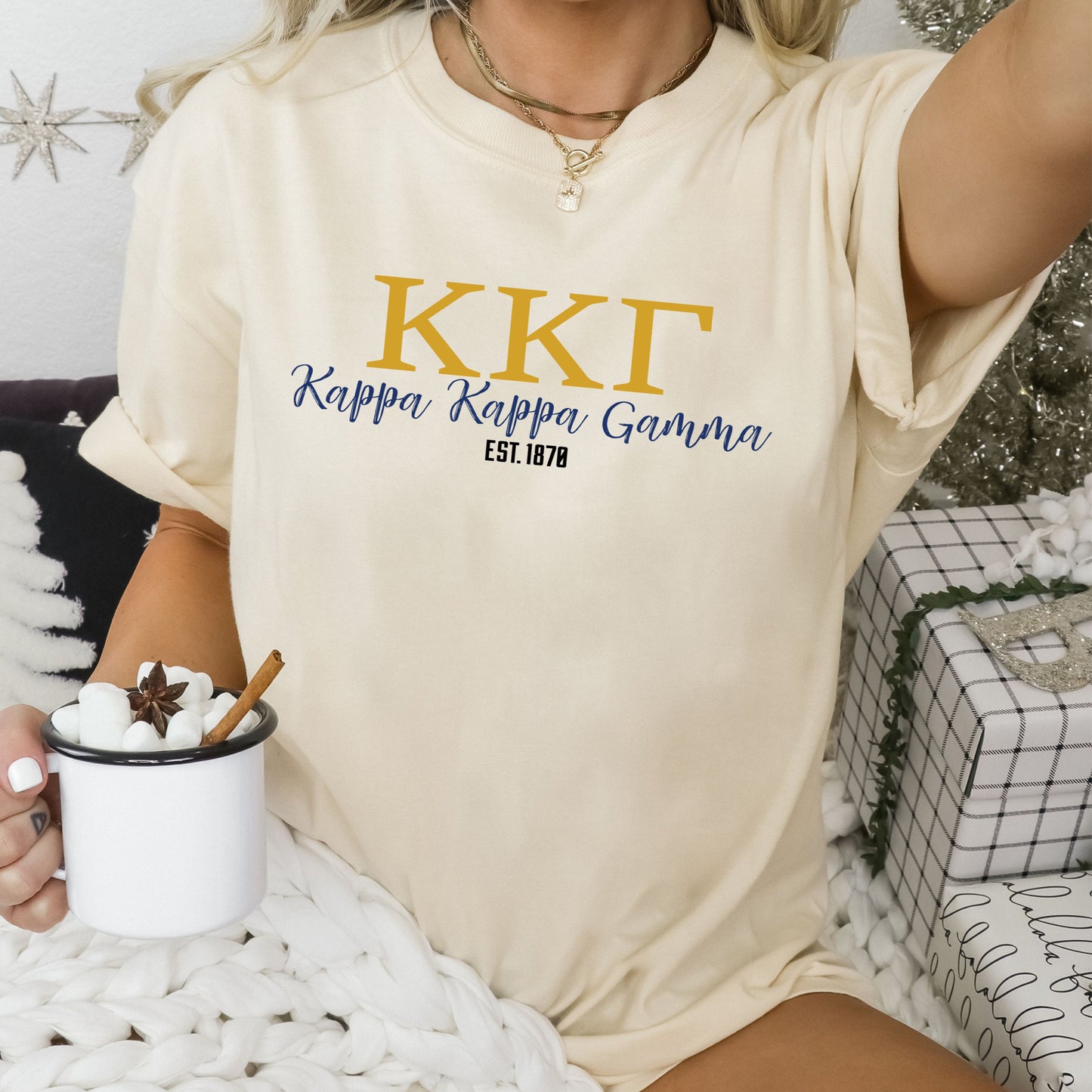 a woman sitting on a bed holding a cup of coffee