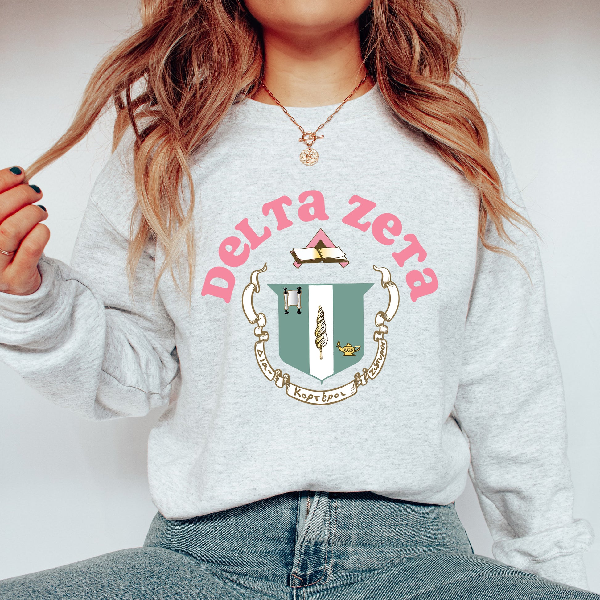 a woman wearing a sweatshirt with a crest on it