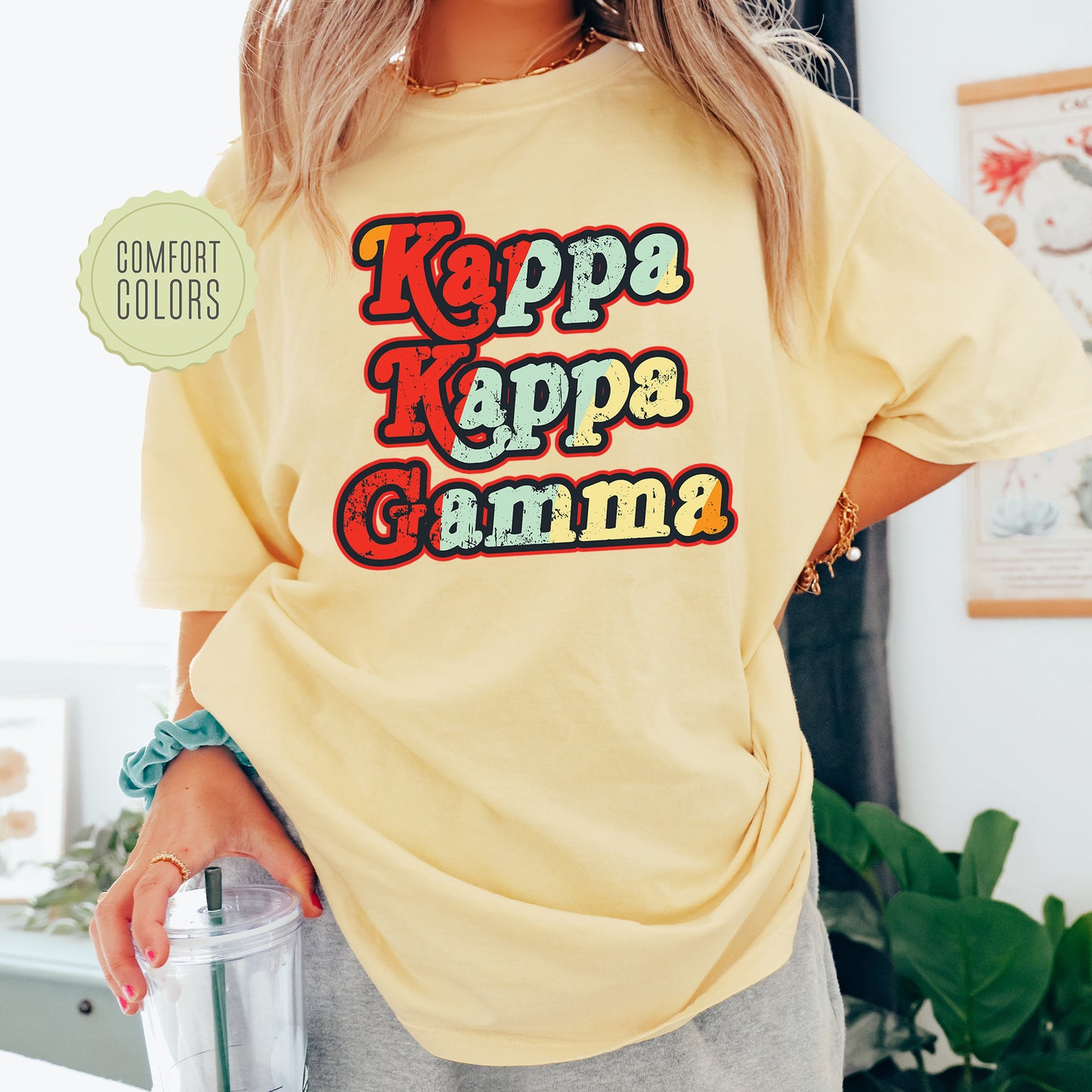 a woman wearing a yellow t - shirt with the words kapa kappa