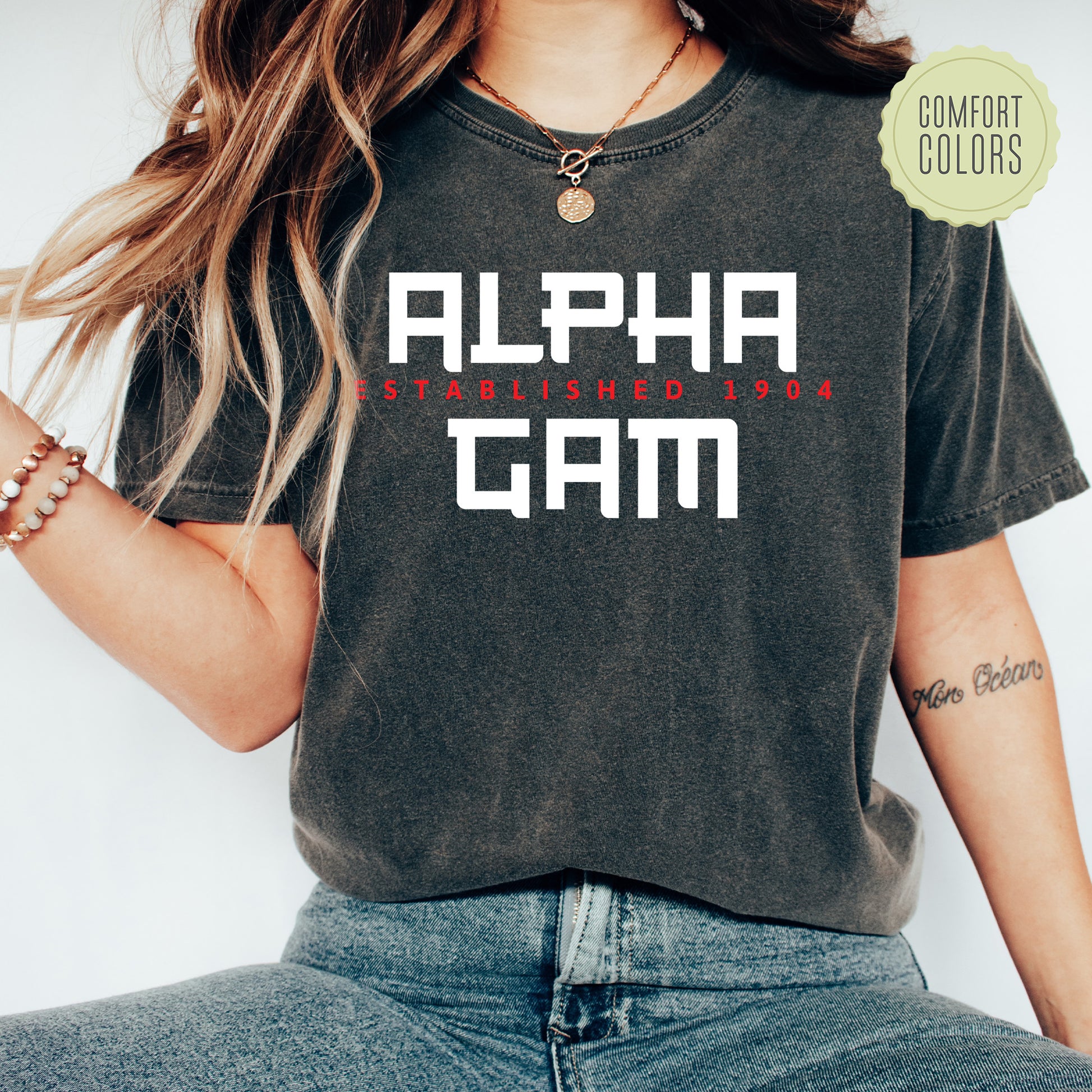 a woman wearing a black shirt with the word alpha gam printed on it