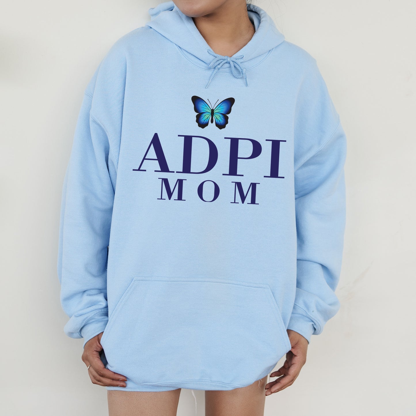 a woman wearing a blue hoodie with a butterfly on it