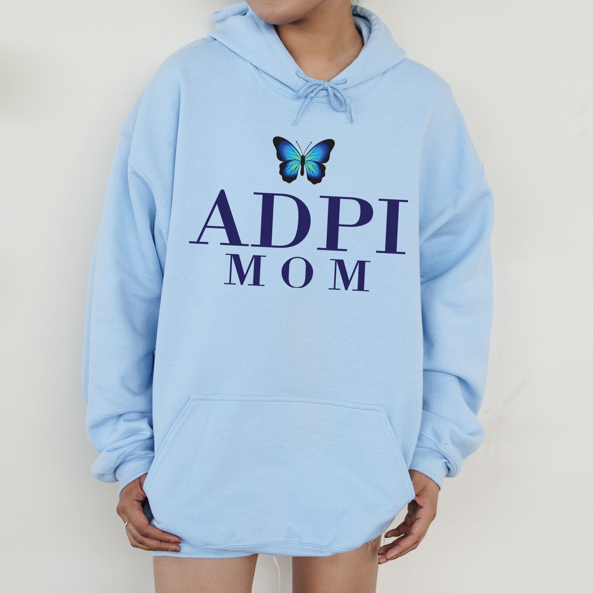 a woman wearing a blue hoodie with a butterfly on it