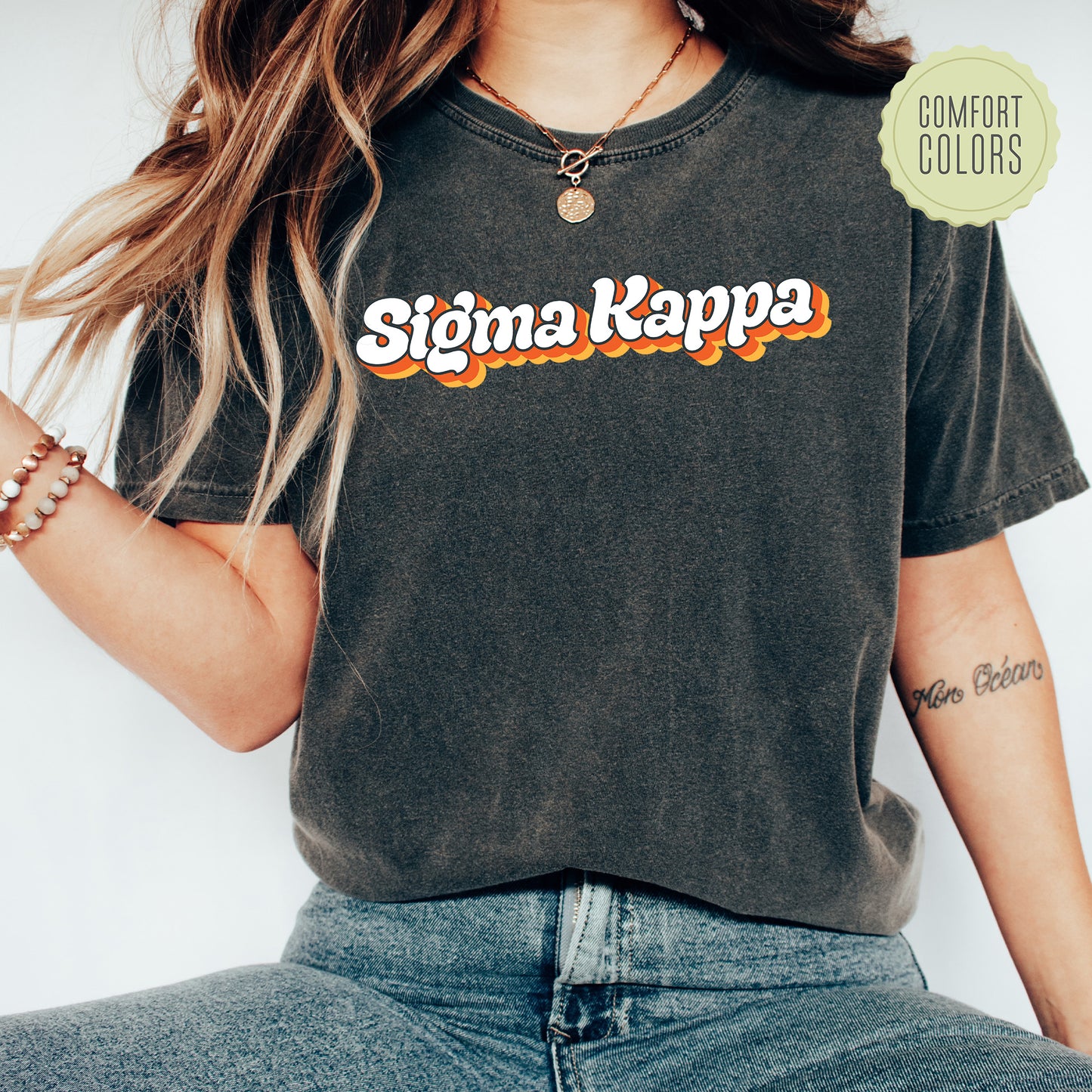 a woman wearing a shirt that says stigma kappa