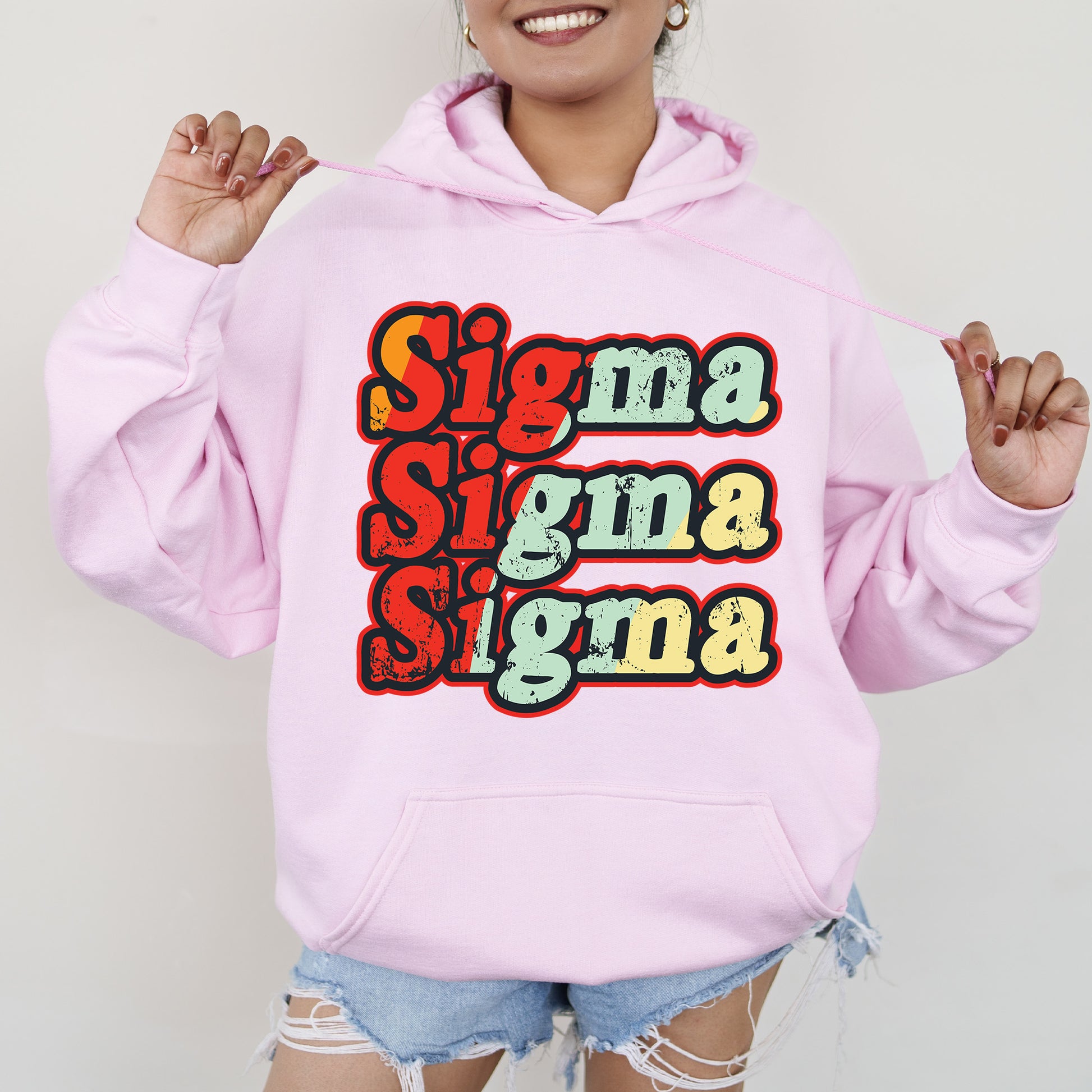 a woman wearing a pink hoodie that says singma singma