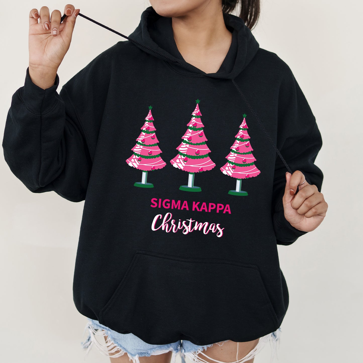 a woman wearing a black sweatshirt with christmas trees on it