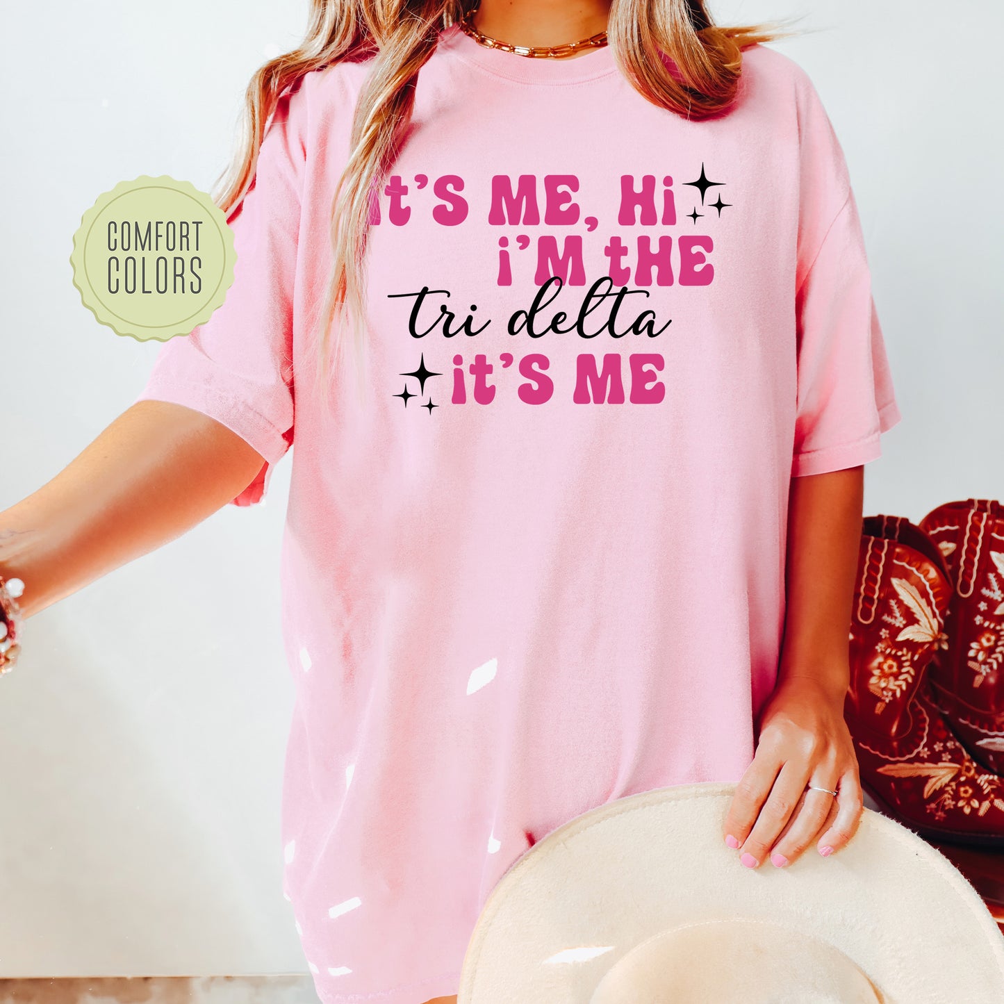 a woman wearing a pink shirt and hat