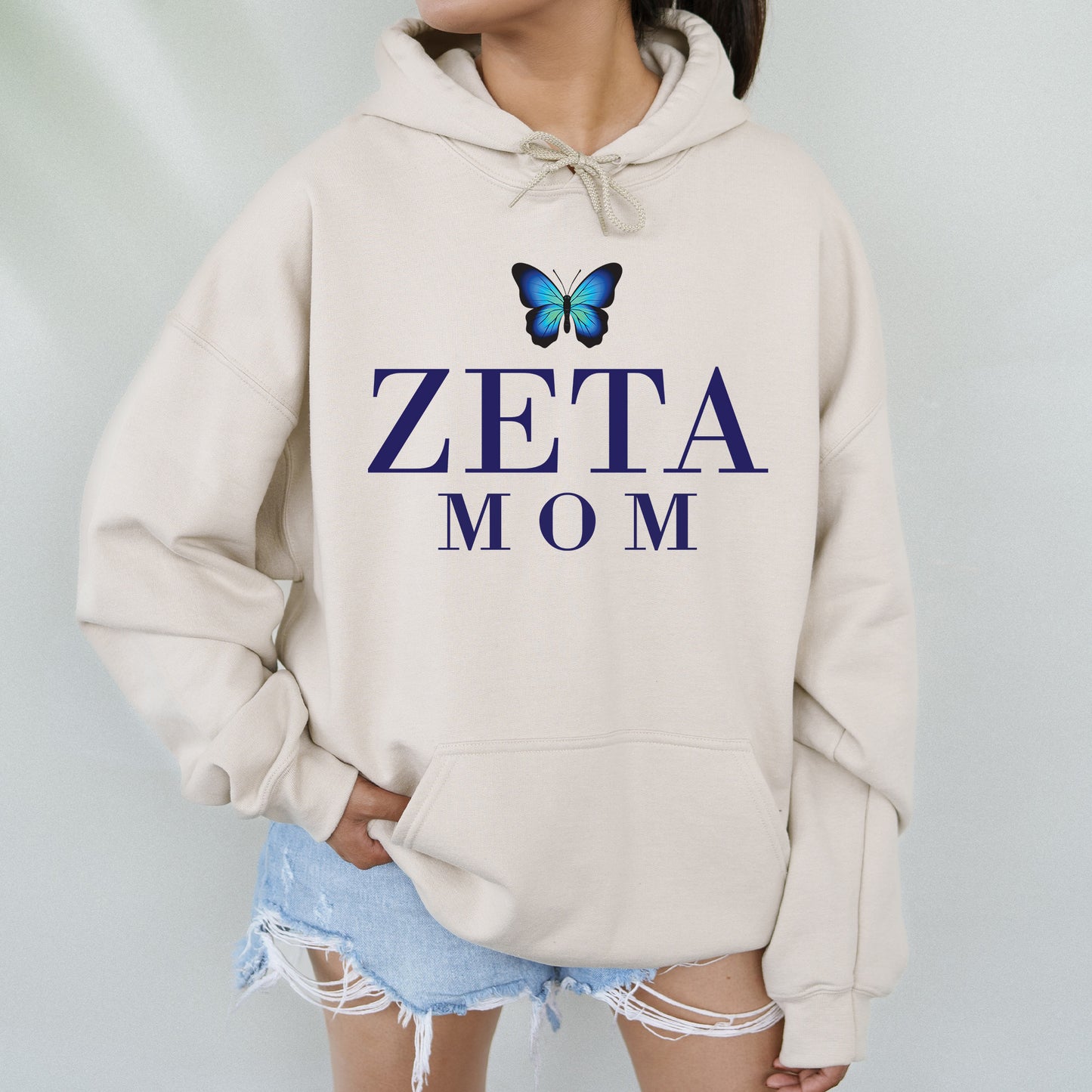 a woman wearing a sweatshirt with a butterfly on it