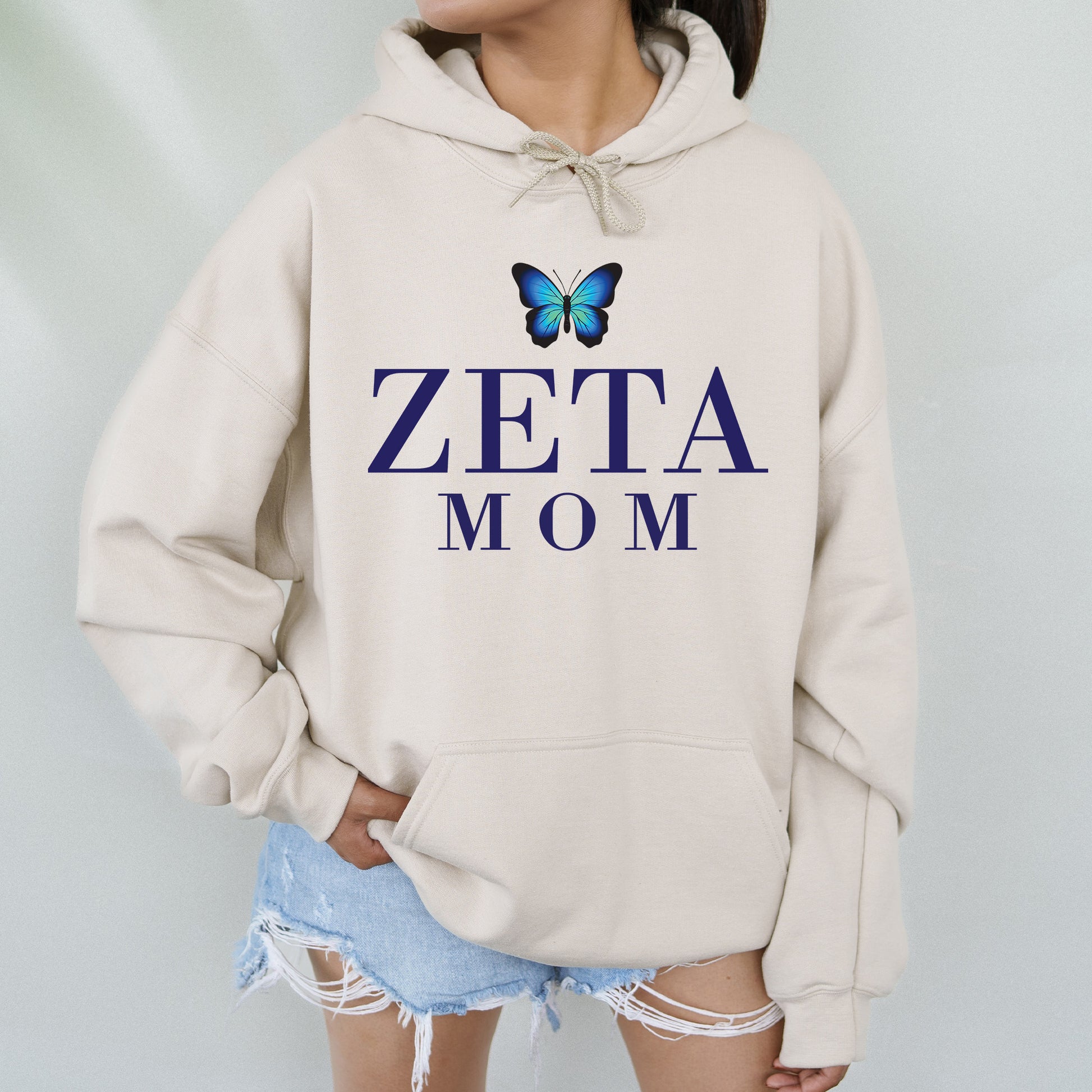 a woman wearing a sweatshirt with a butterfly on it