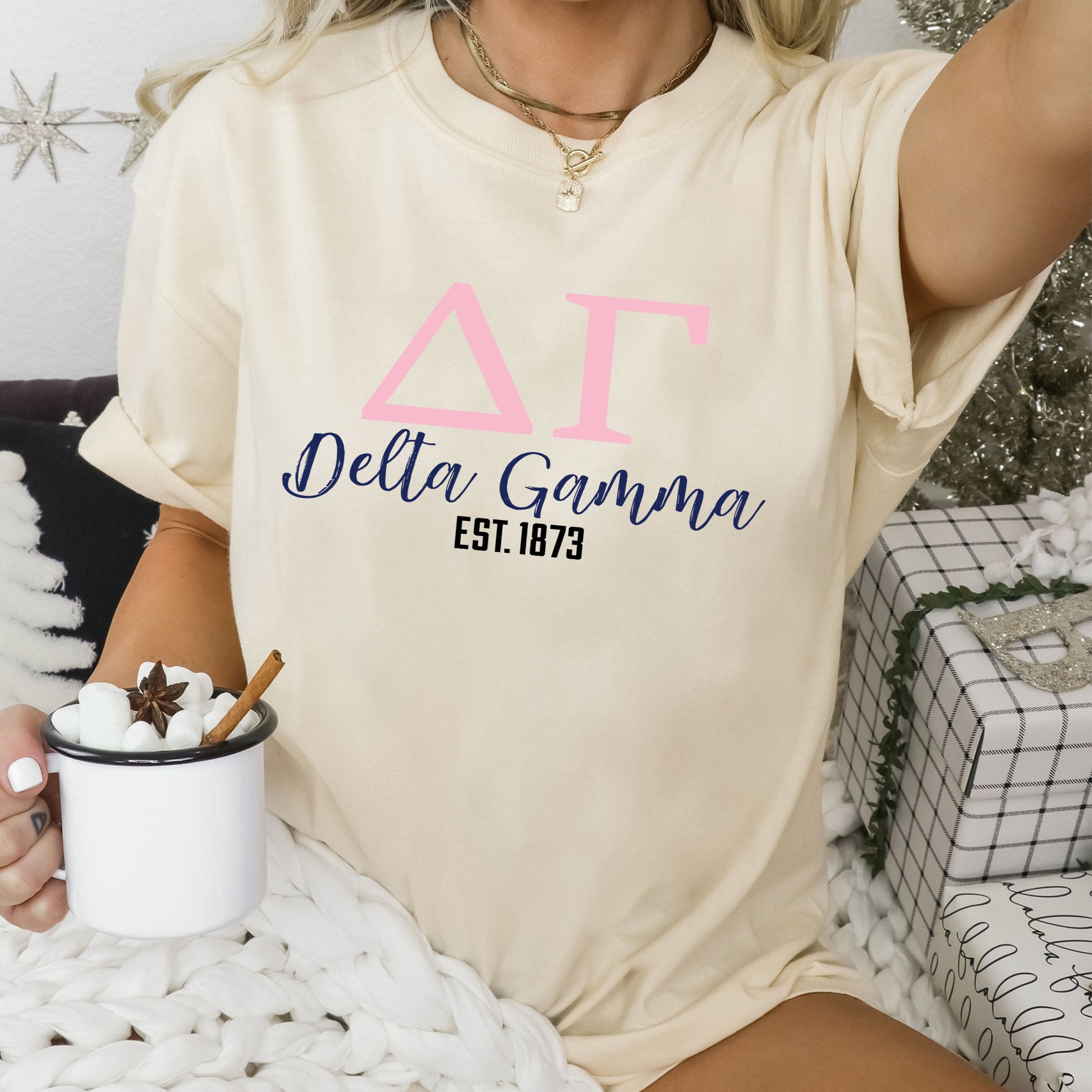 a woman sitting on a bed holding a cup of coffee