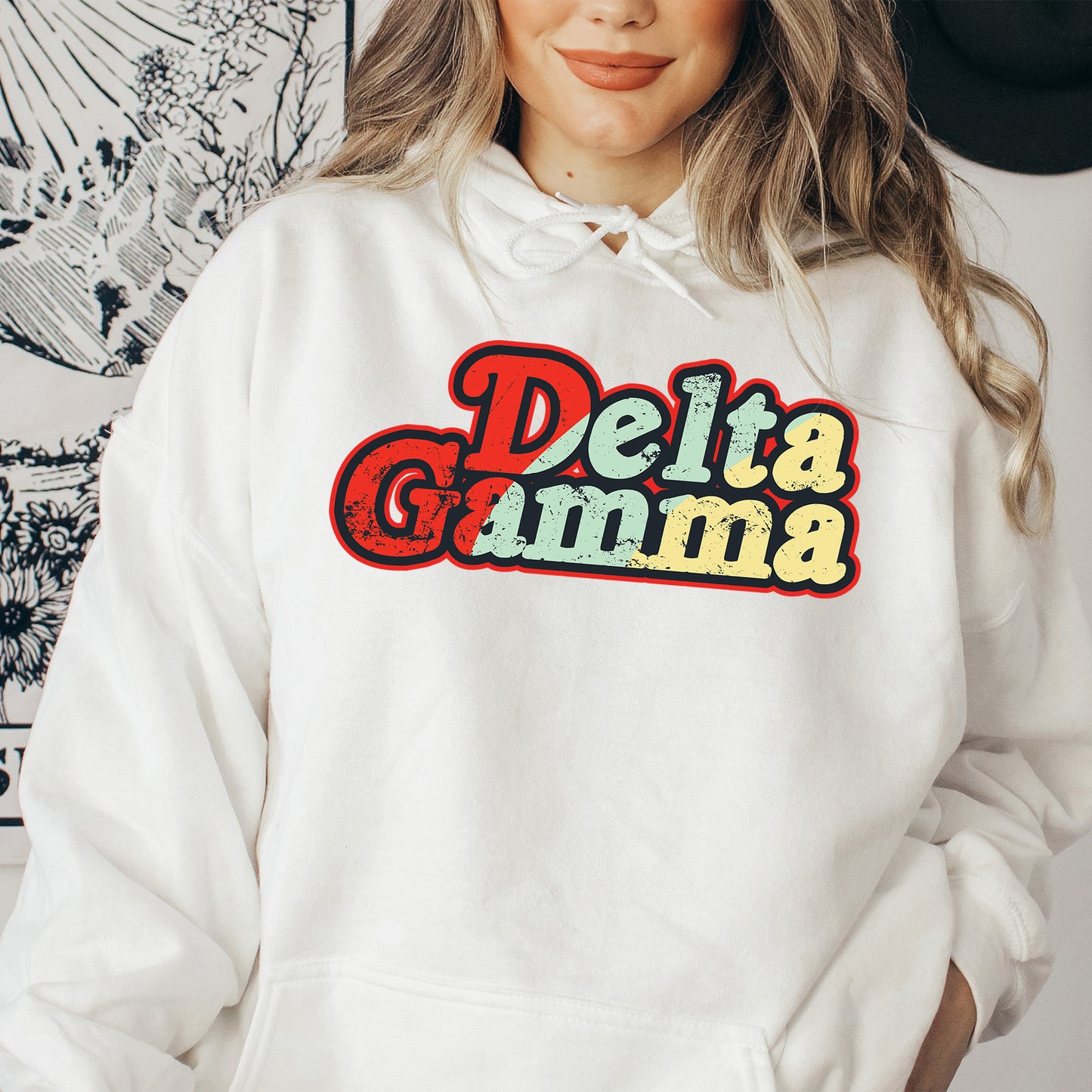 a woman wearing a white hoodie with the words delta gumma on it