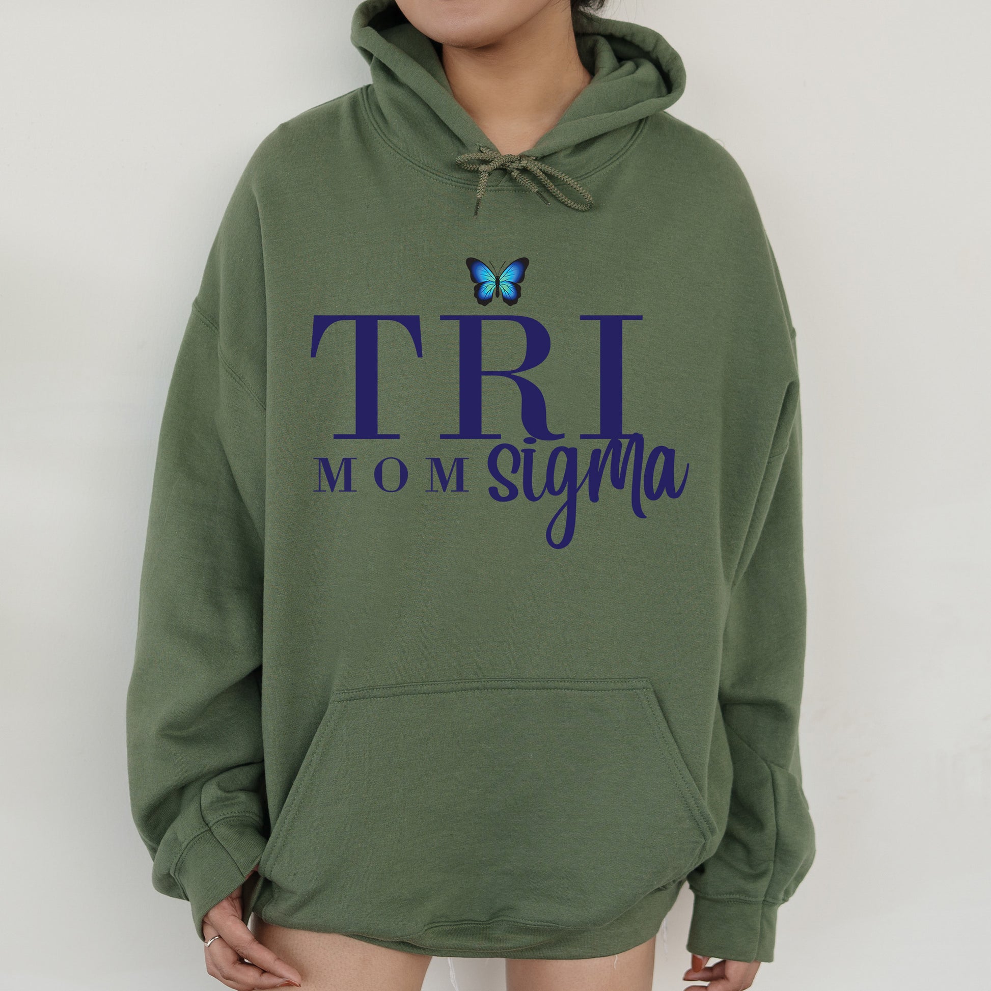 a woman wearing a green hoodie with a butterfly on it
