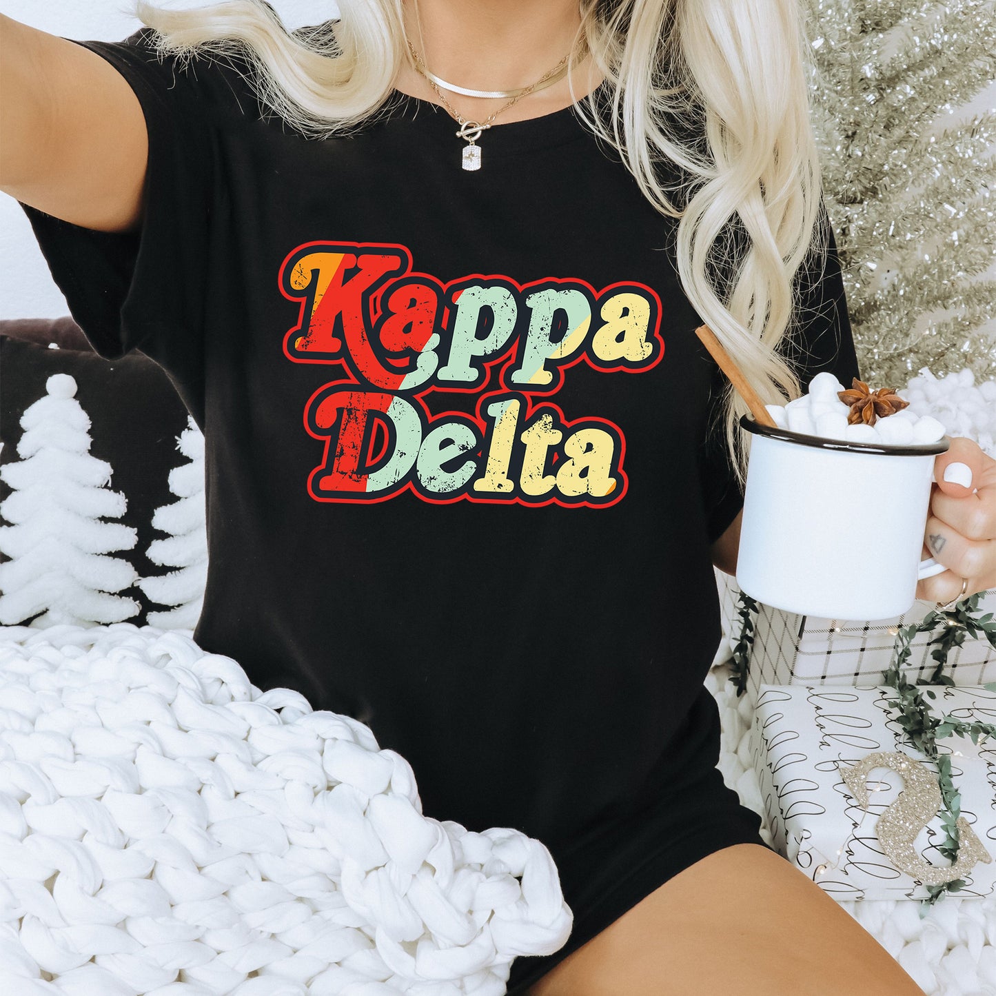 a woman sitting on a couch holding a cup of coffee