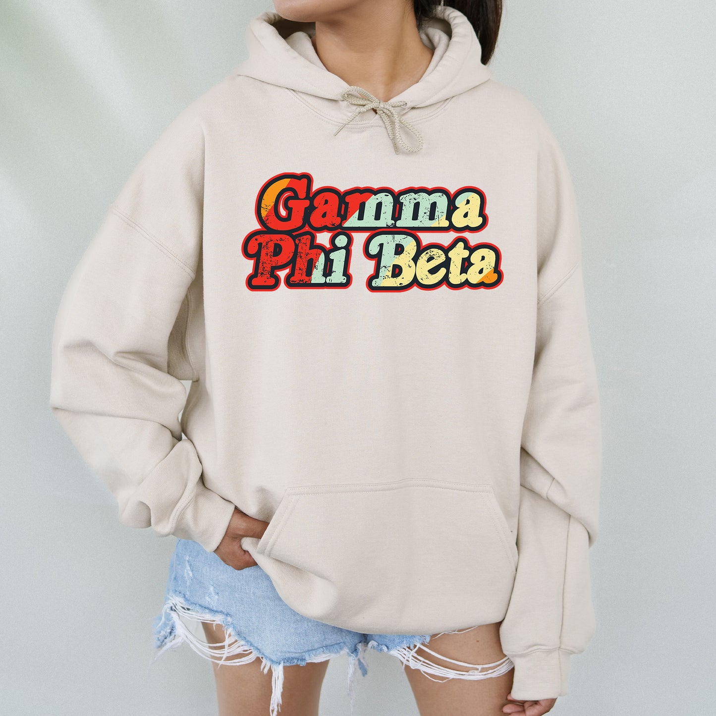 a woman wearing a white hoodie that says garma pi beta