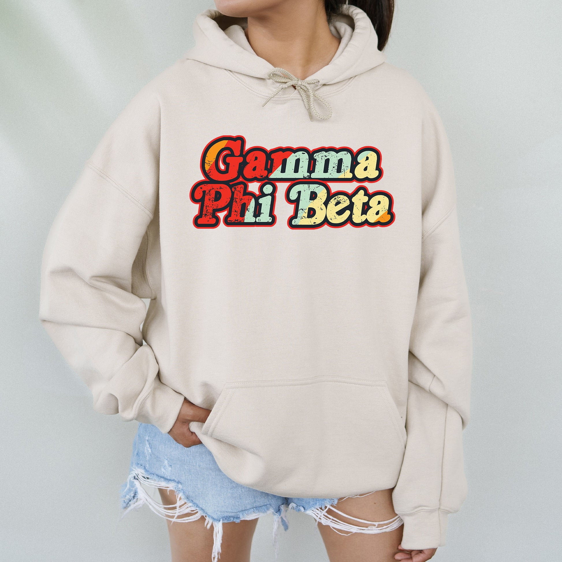 a woman wearing a white hoodie that says garma pi beta
