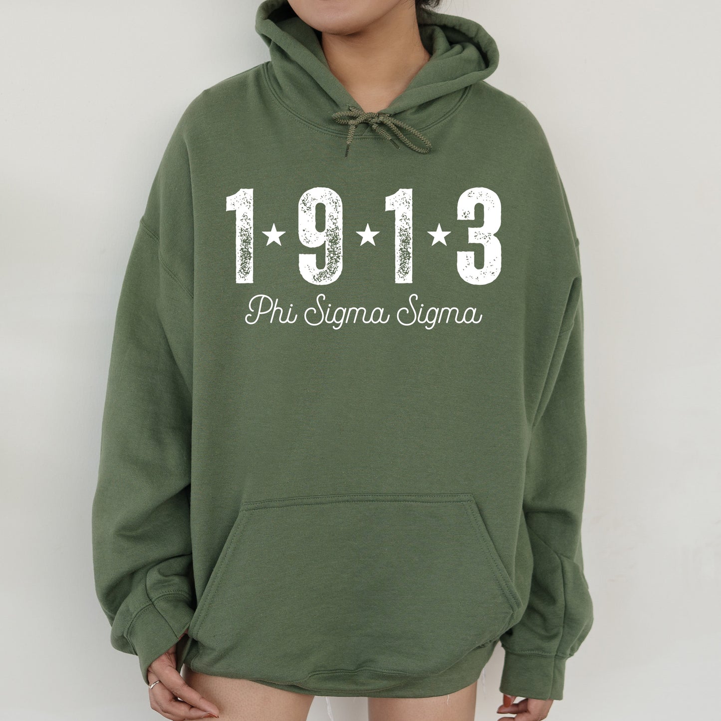 a woman wearing a green hoodie with the number 1911 printed on it