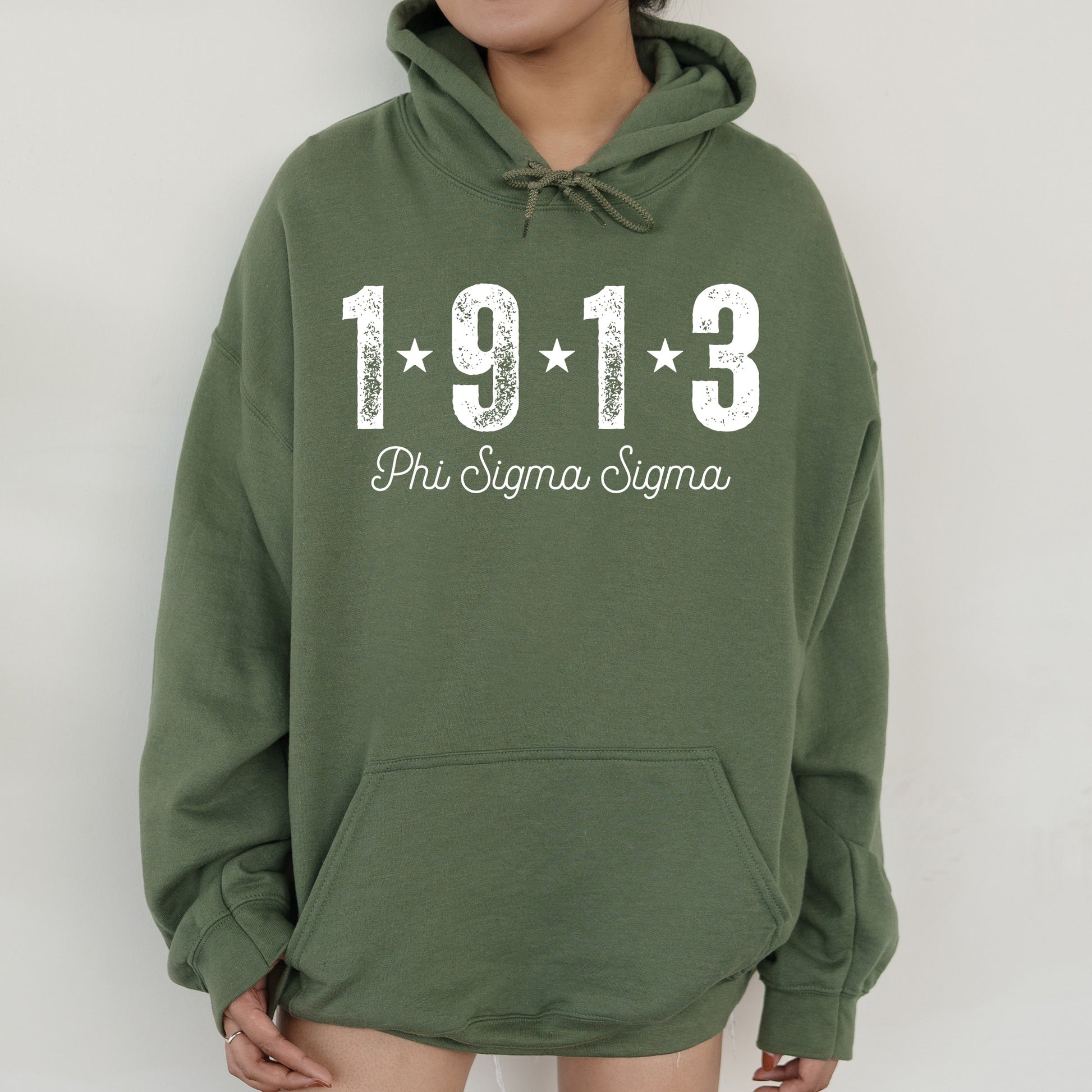 a woman wearing a green hoodie with the number 1911 printed on it