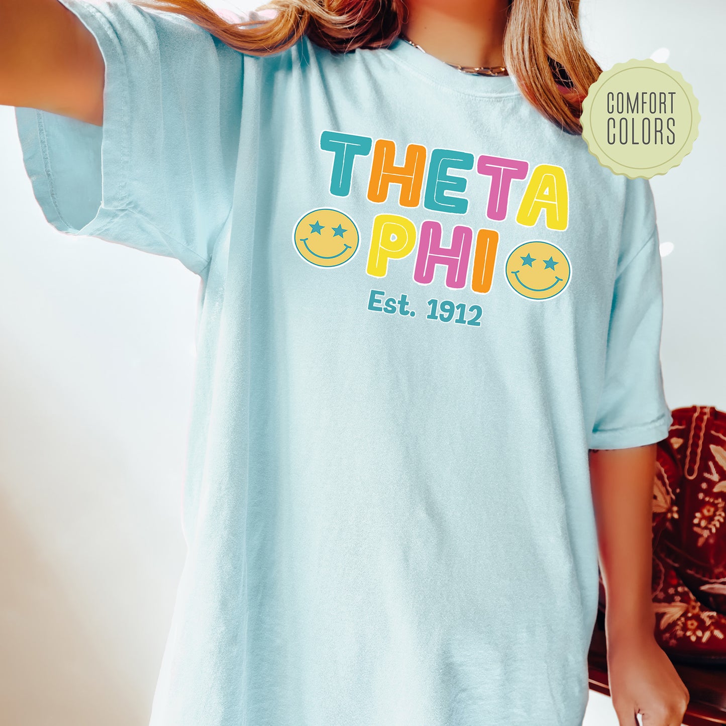 a woman wearing a t - shirt that says thea phi est 1932