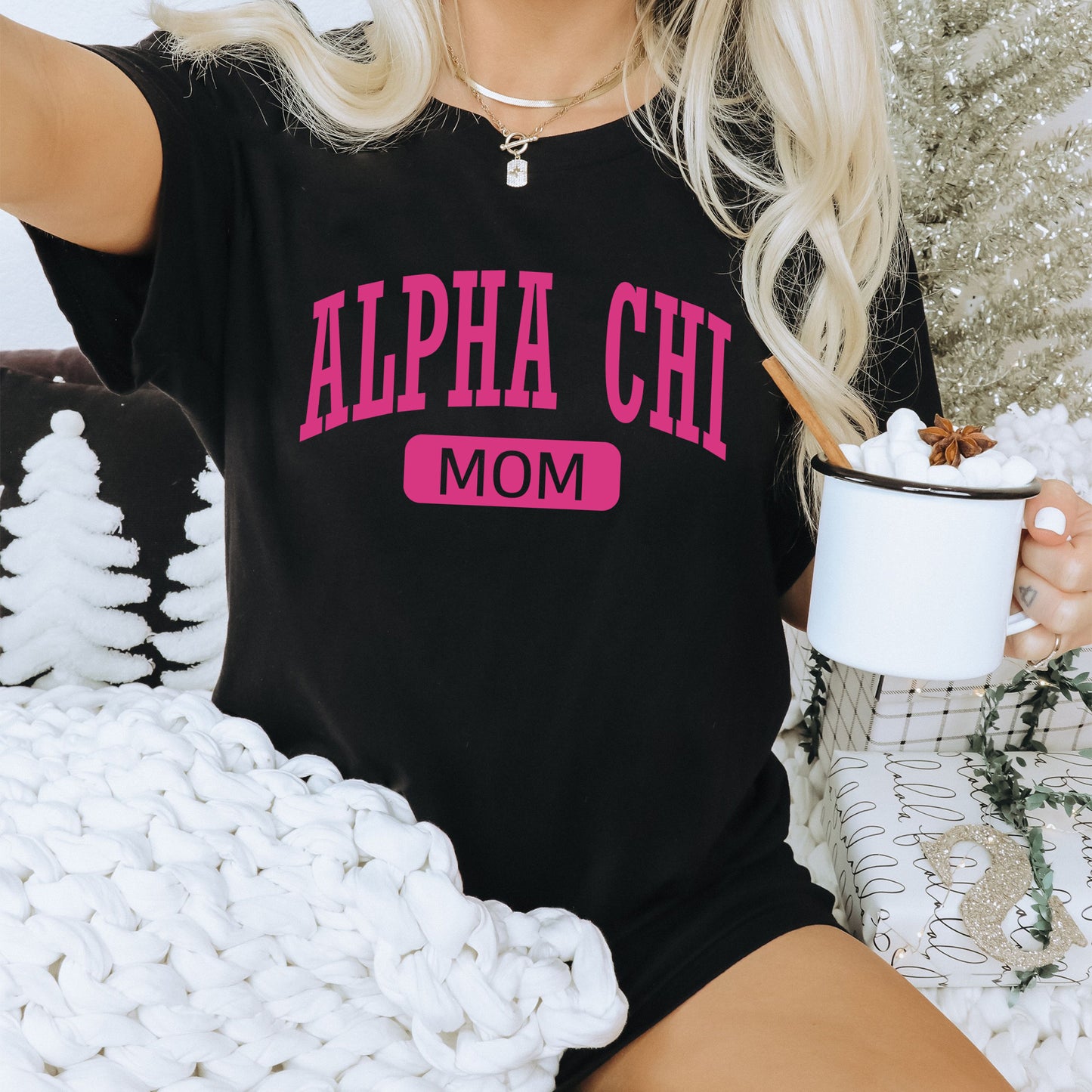 a woman sitting on a couch holding a cup of coffee