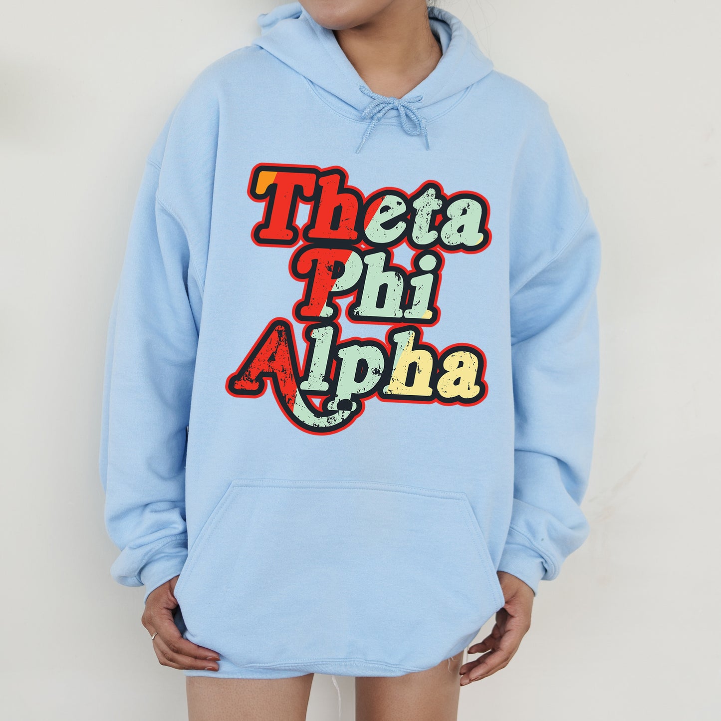 a person wearing a blue hoodie that says thea phi aloha