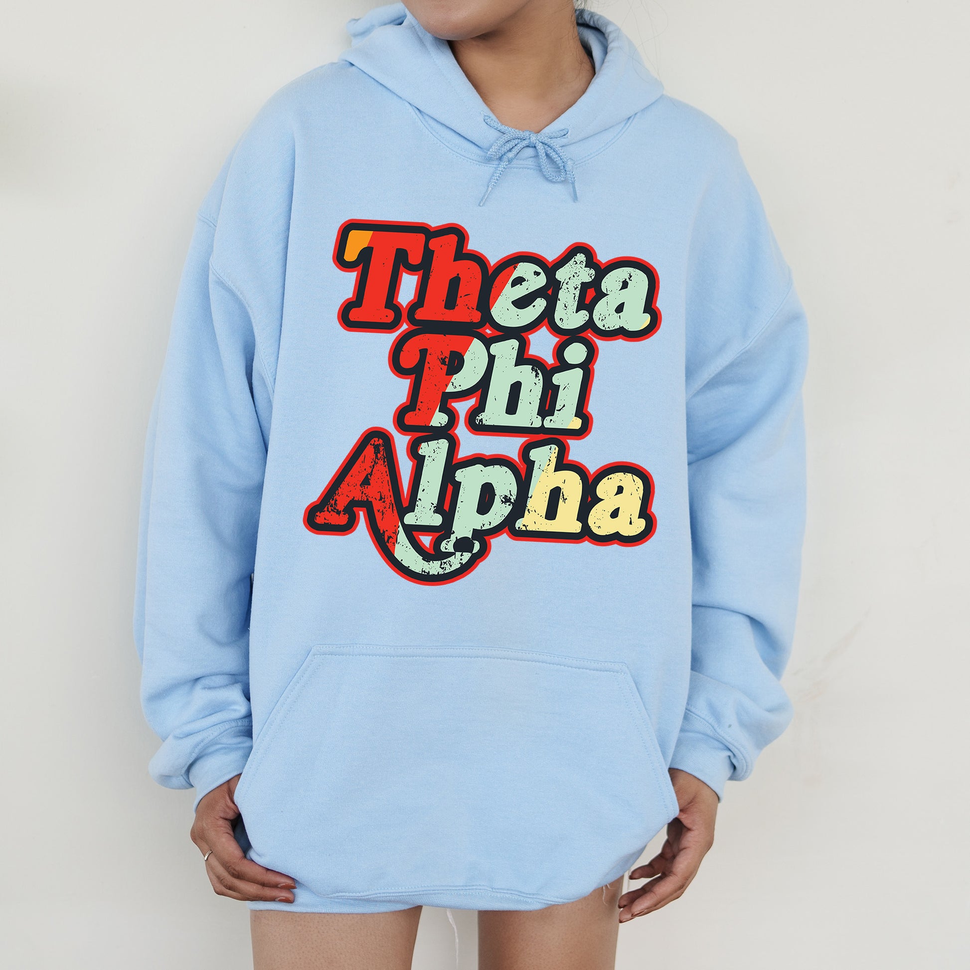 a person wearing a blue hoodie that says thea phi aloha