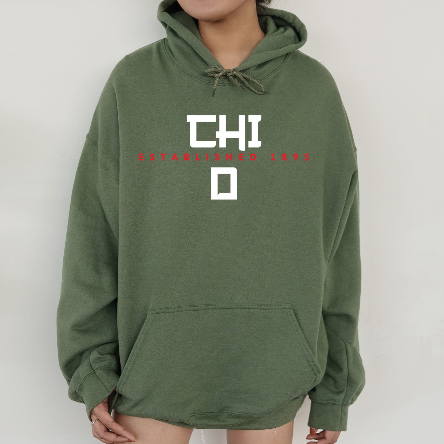 a person wearing a green hoodie with the words chd on it