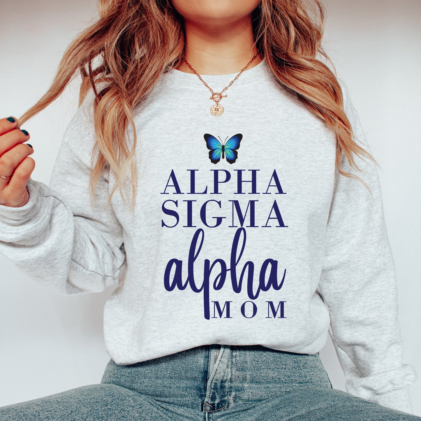 a woman wearing a sweatshirt with a butterfly on it