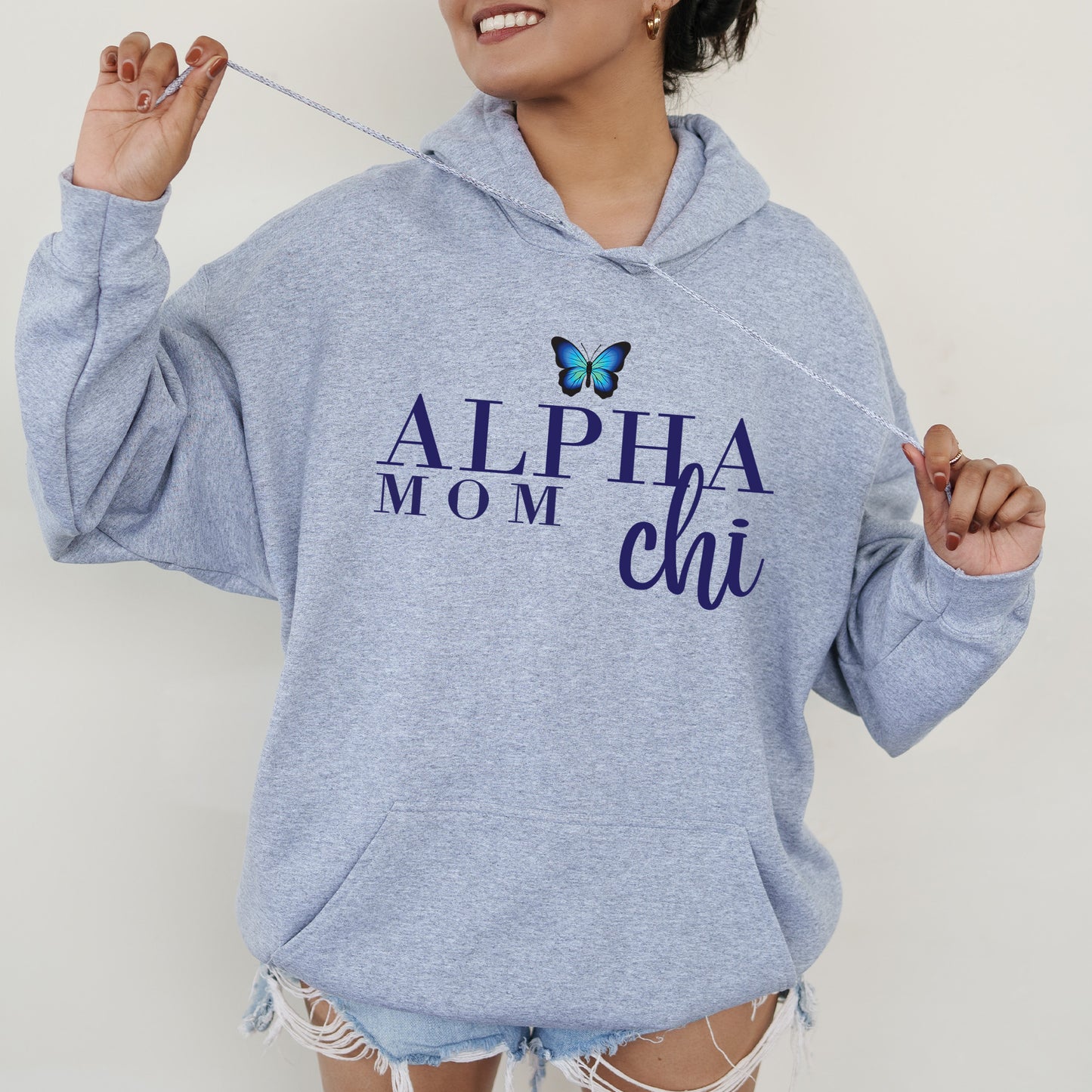 a woman in a blue hoodie holding a toothbrush