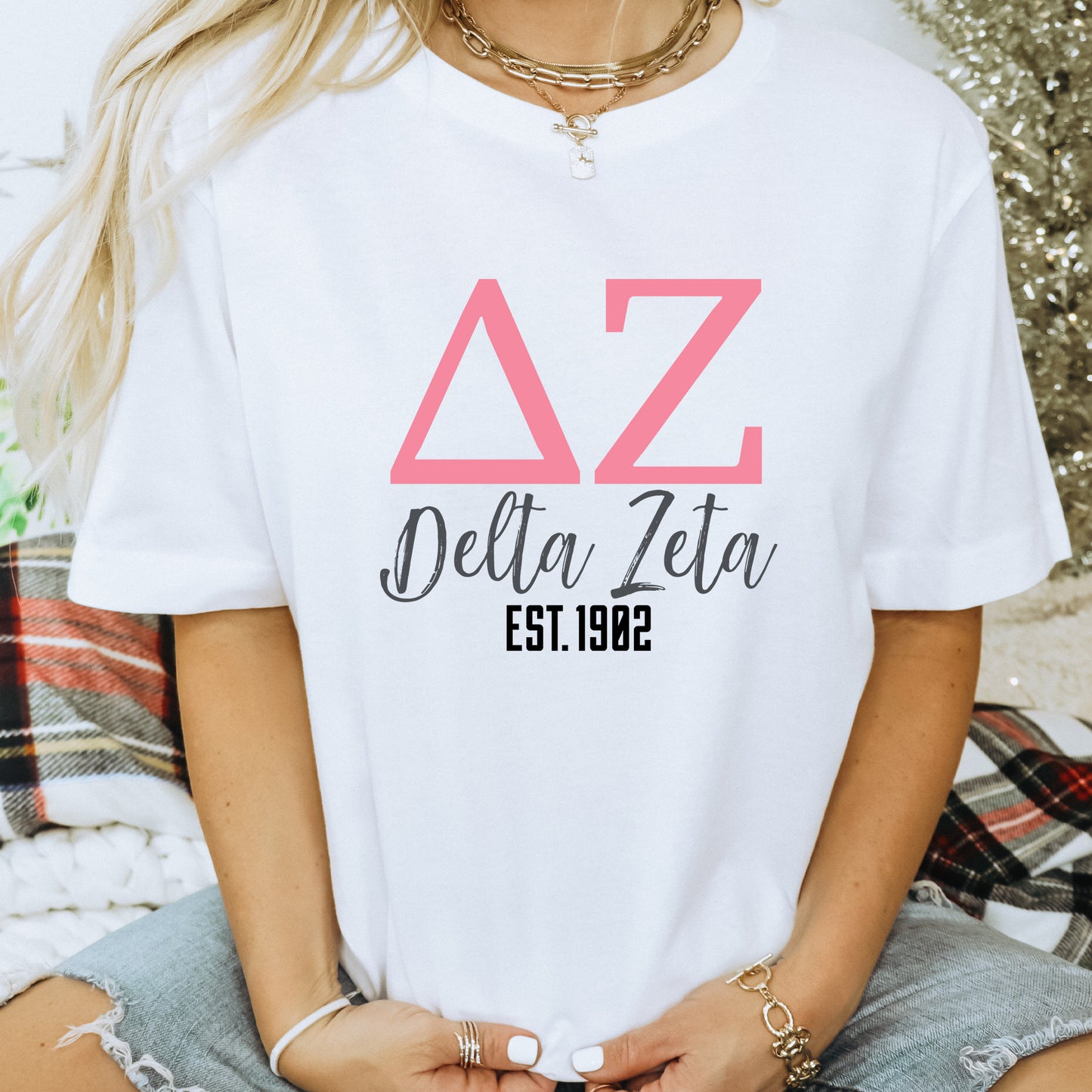 a woman wearing a white delta delta t - shirt