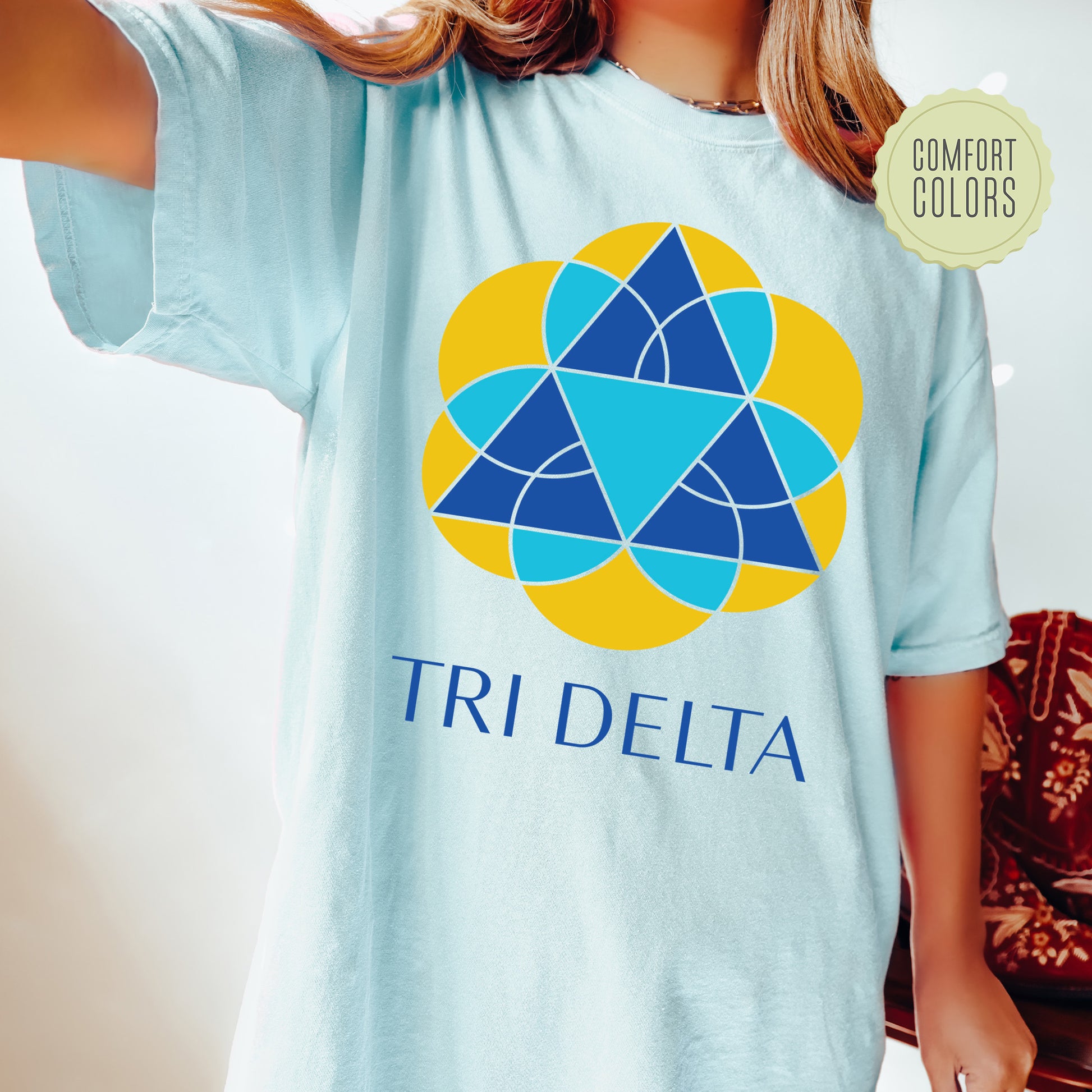 a girl wearing a blue tri delta t - shirt