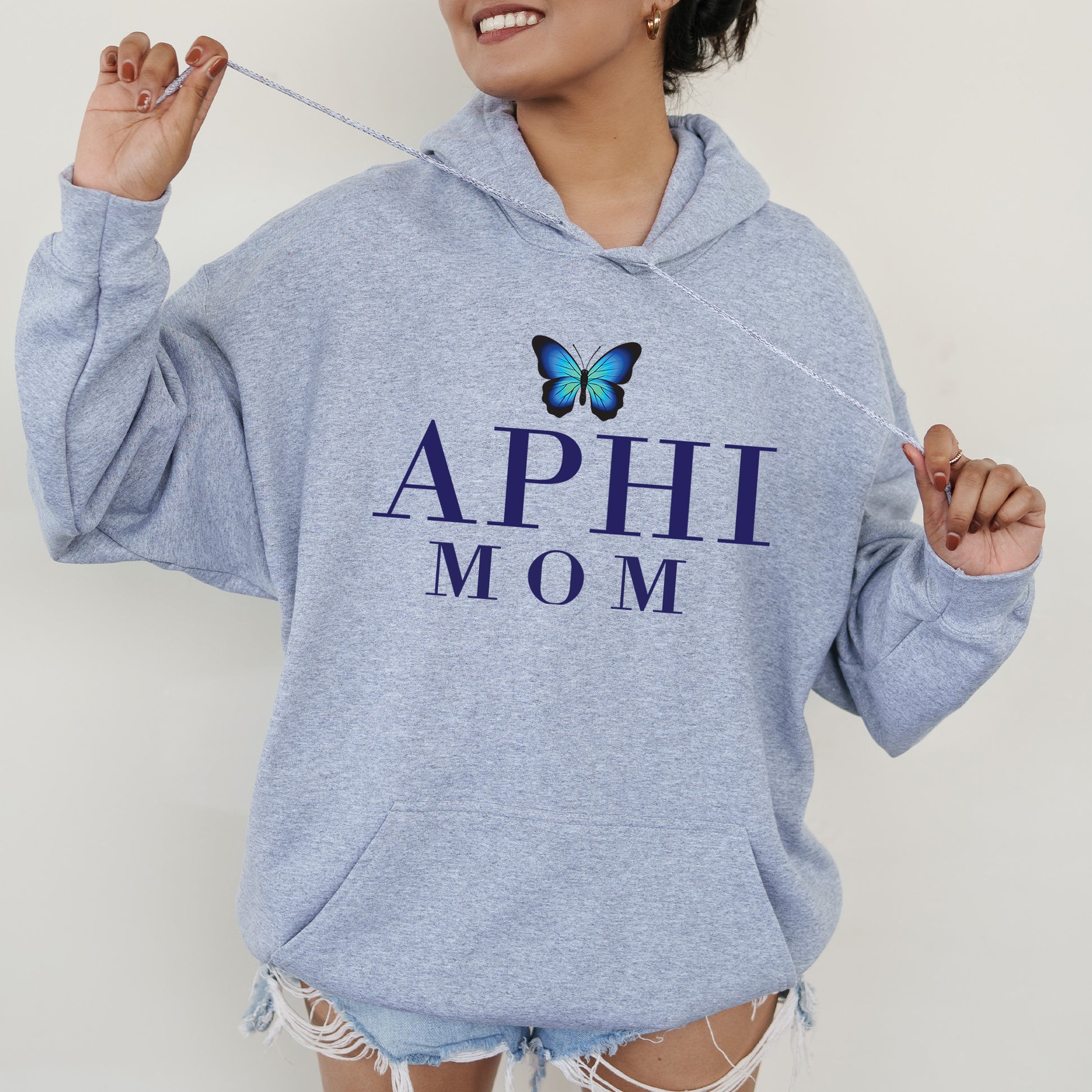 a woman wearing a blue hoodie with a butterfly on it