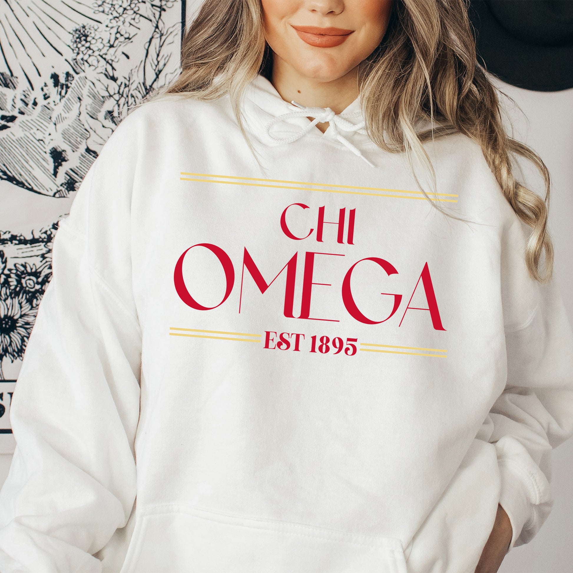 a woman wearing a white hoodie with a red omega on it