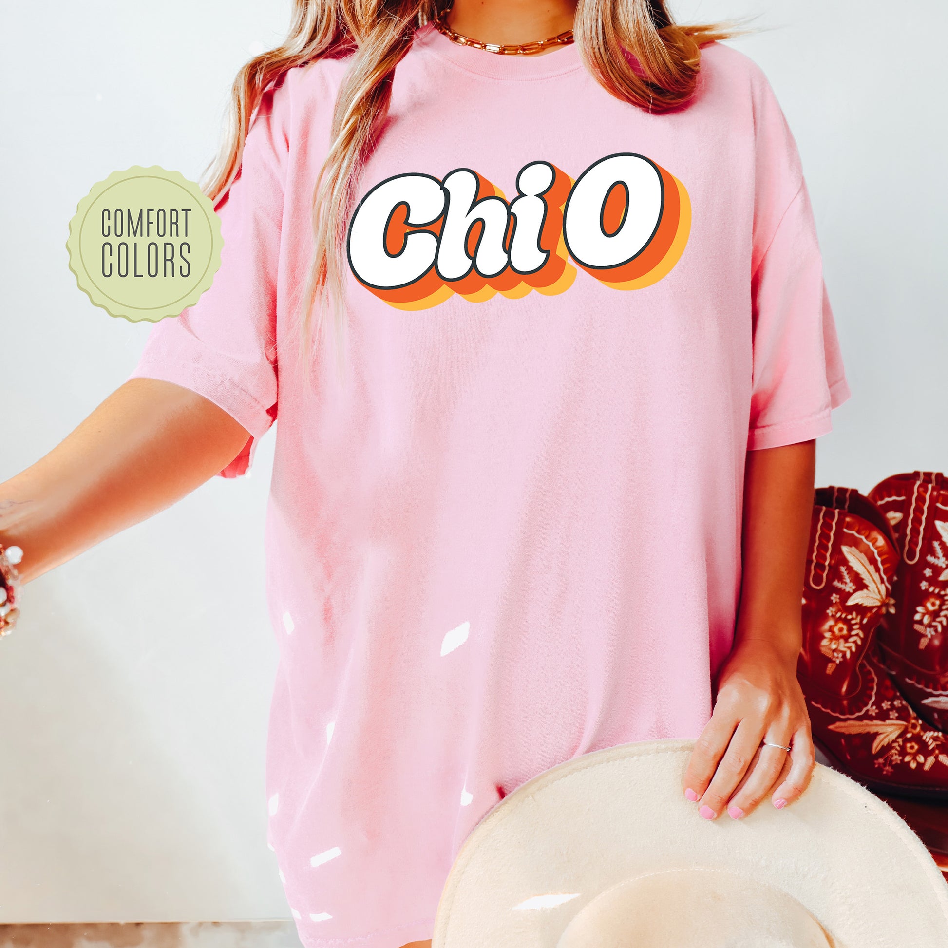 a woman wearing a pink shirt with the word chio on it