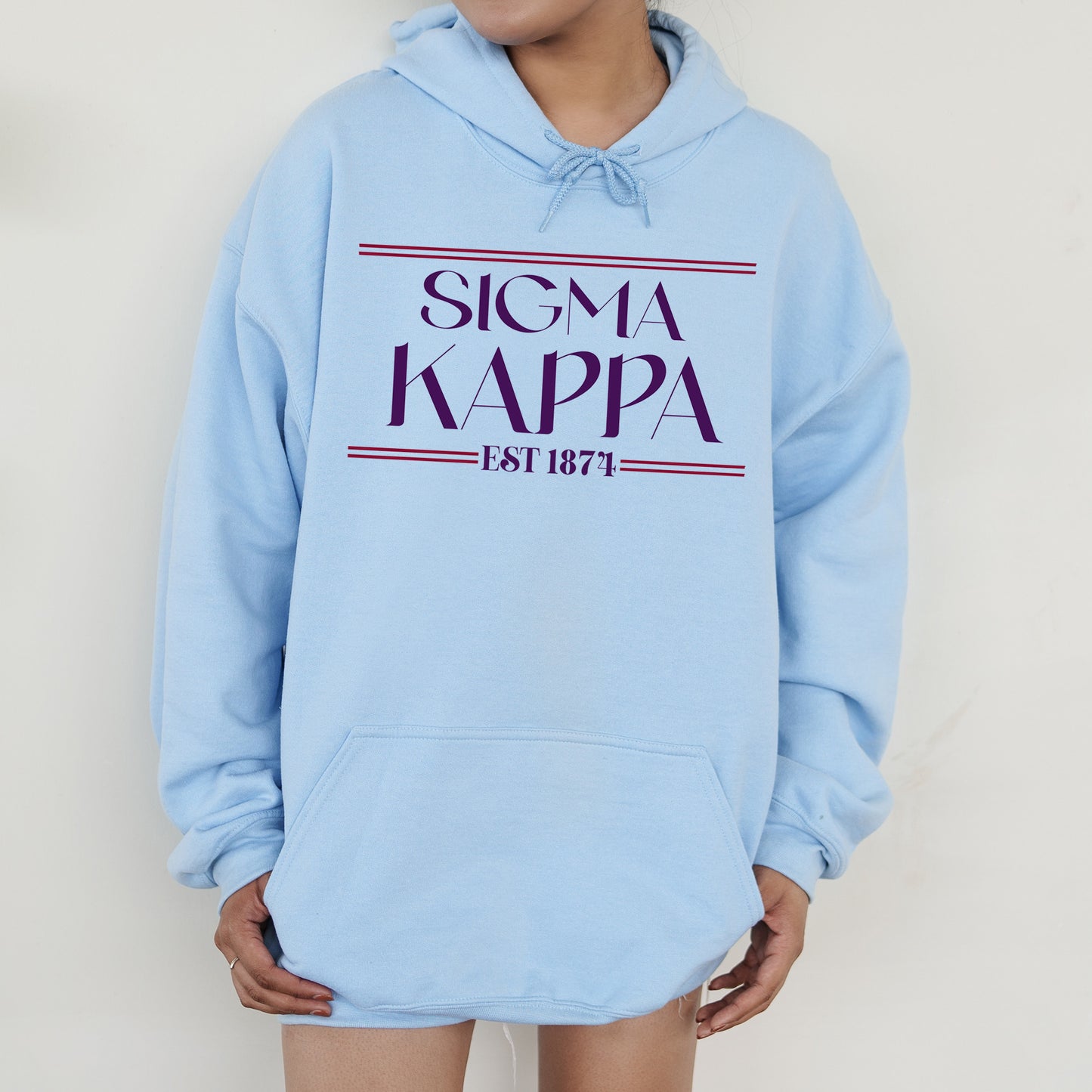 a woman wearing a blue sweatshirt with the name of a famous singer