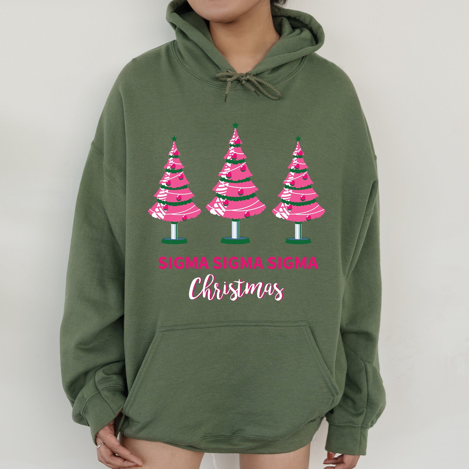 a woman wearing a green sweatshirt with pink trees on it