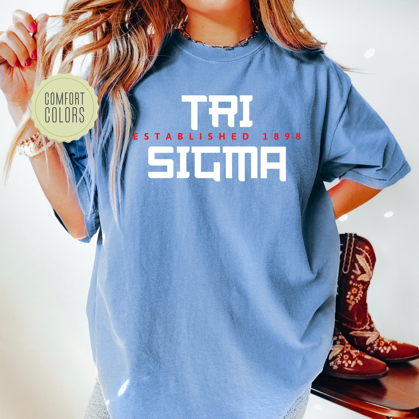 a woman wearing a blue t - shirt with the word tri stigma printed on it