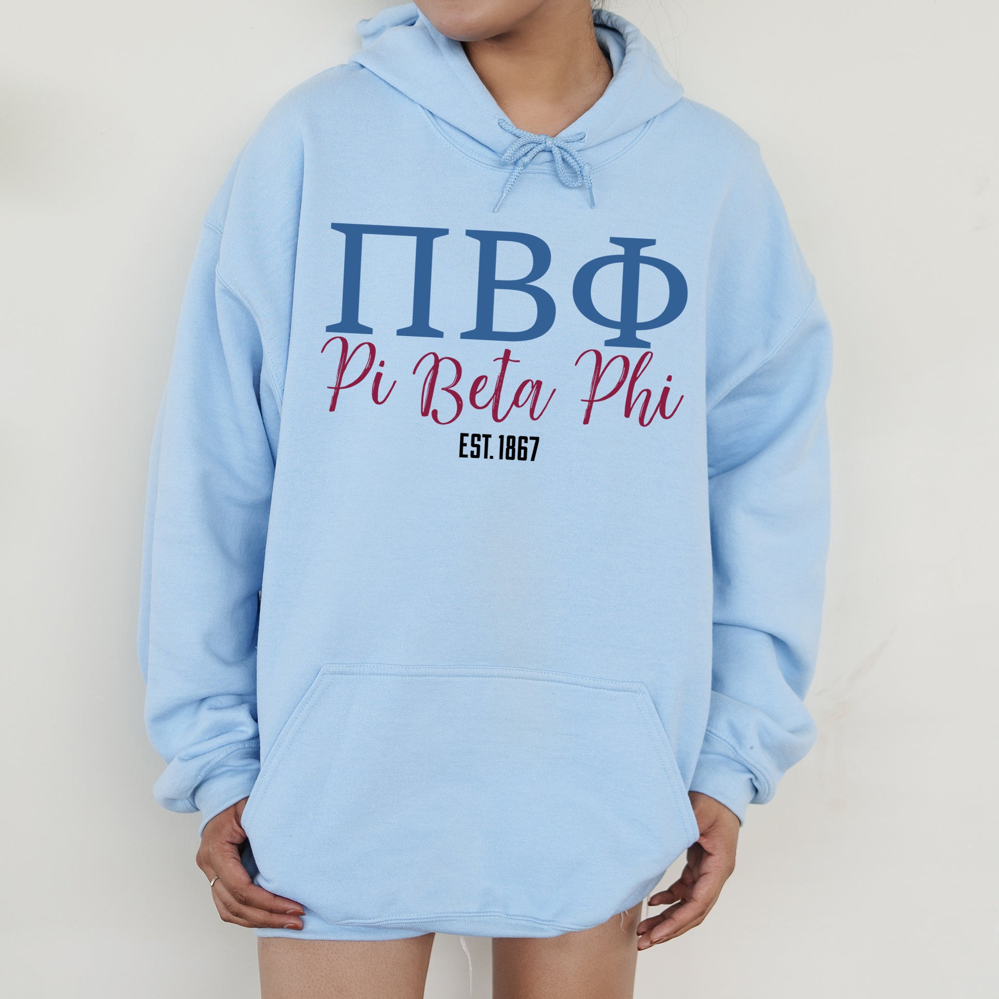 a woman wearing a blue hoodie that says pi beta phi