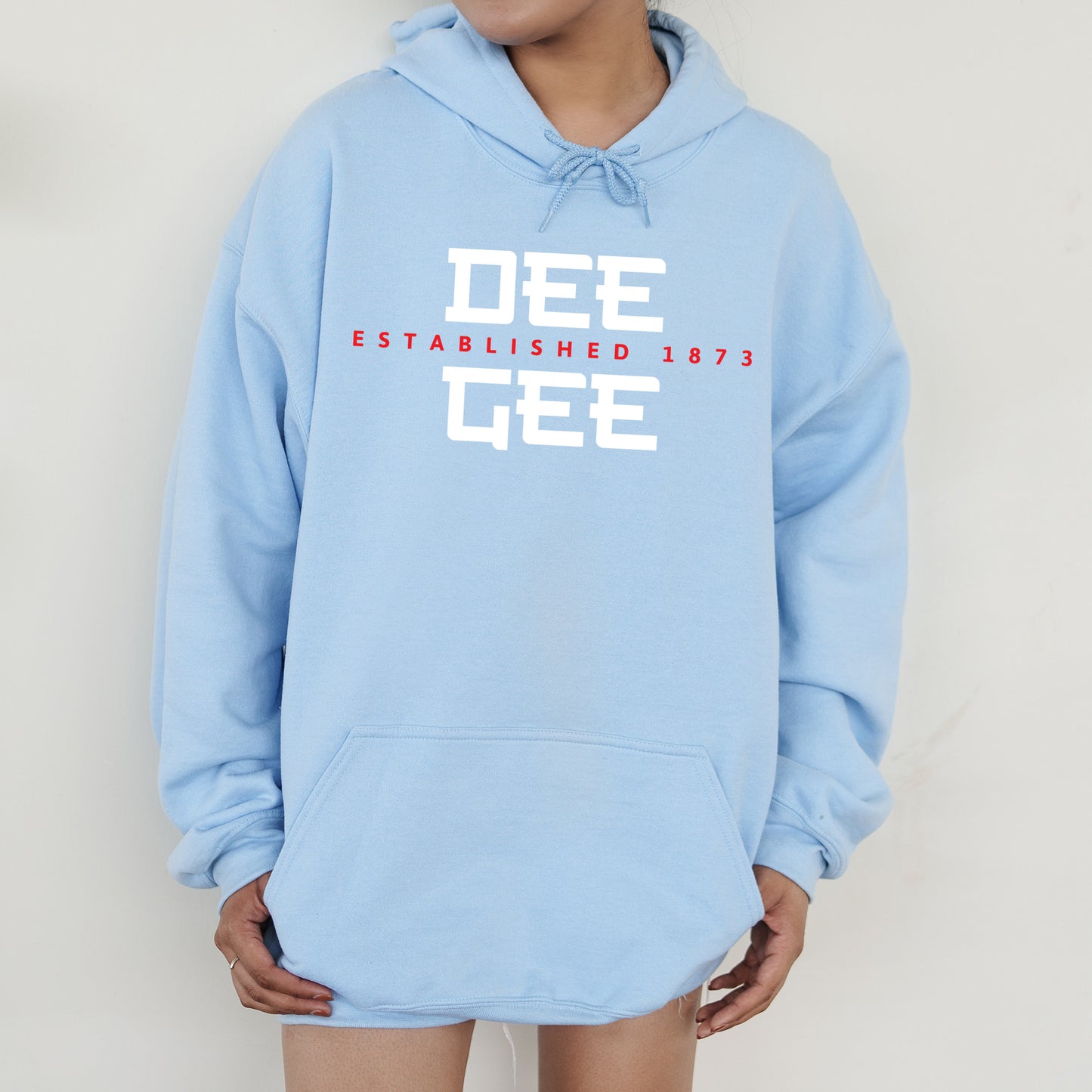 a person wearing a blue hoodie that says dee established 1971