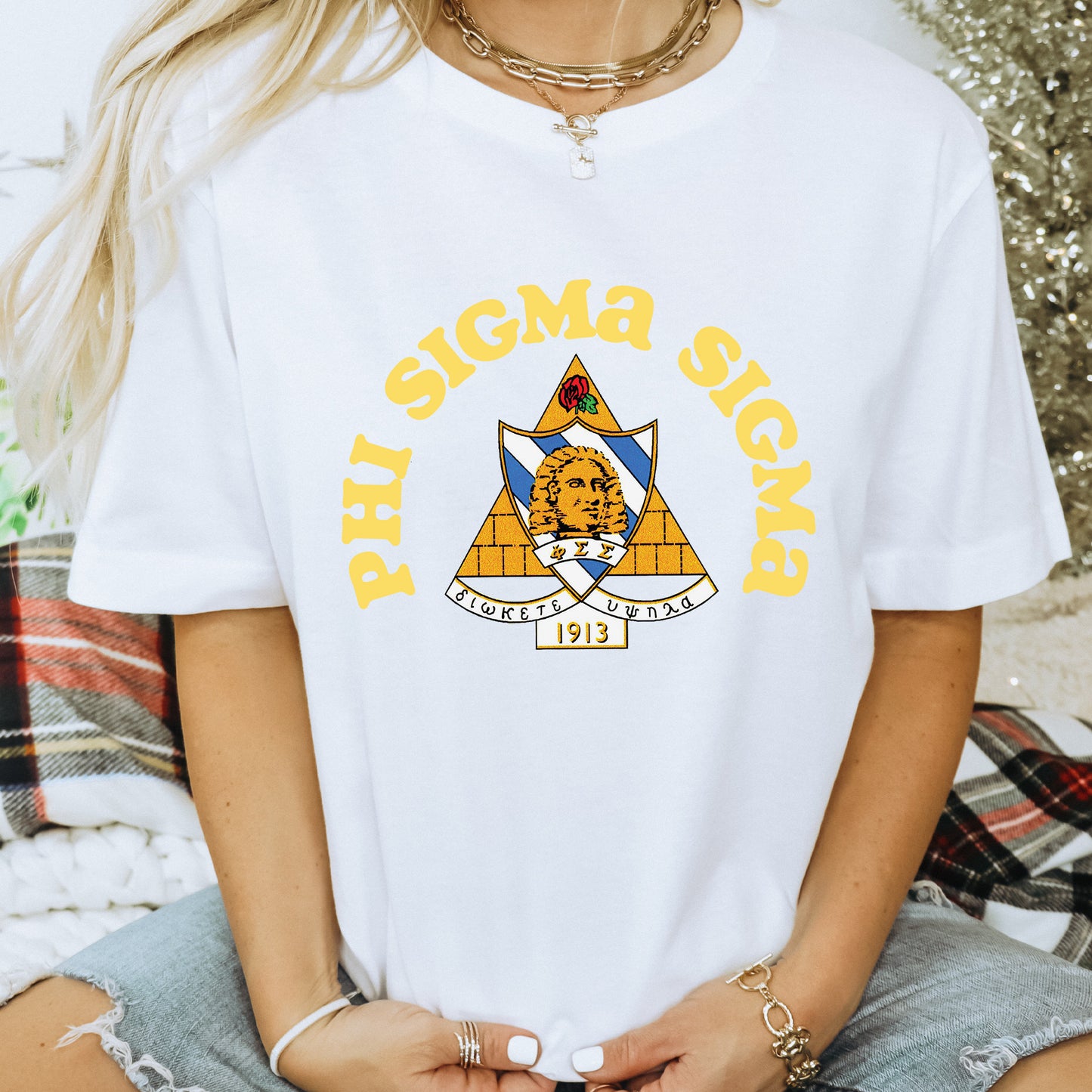 a woman wearing a white t - shirt with a yellow triangle on it